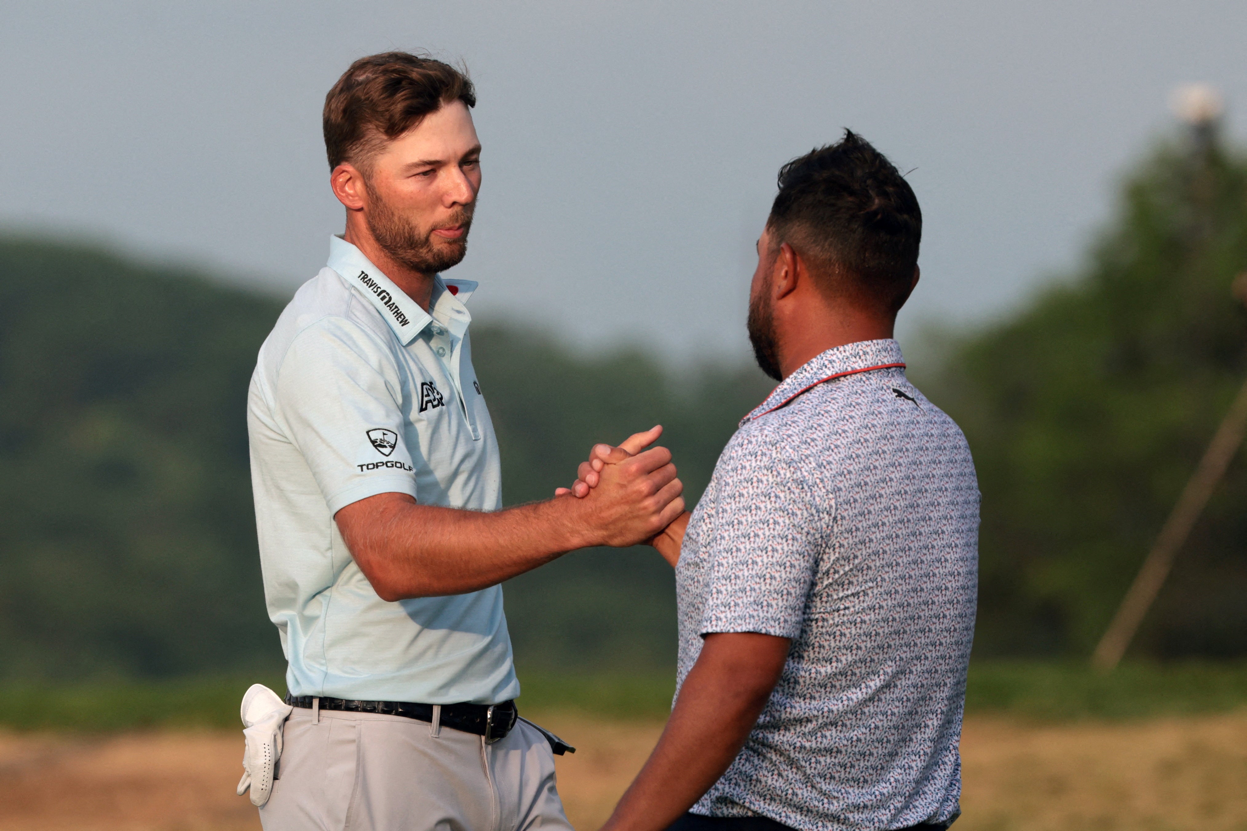Sam Burns (left) leads JJ Spaun (right) by a single stroke