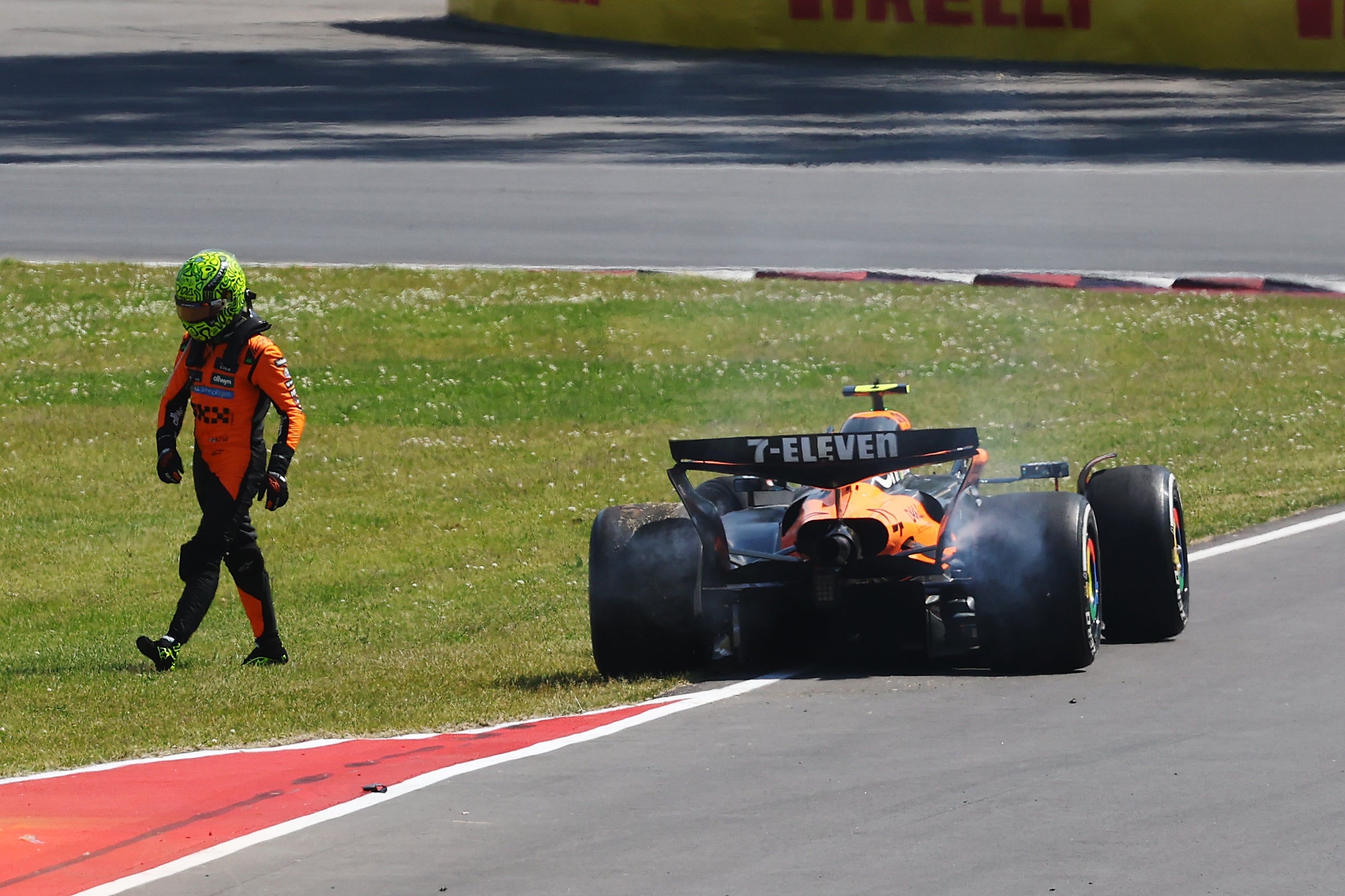 Lando Norris walks away from his stricken McLaren car after his collision with Oscar Piastri