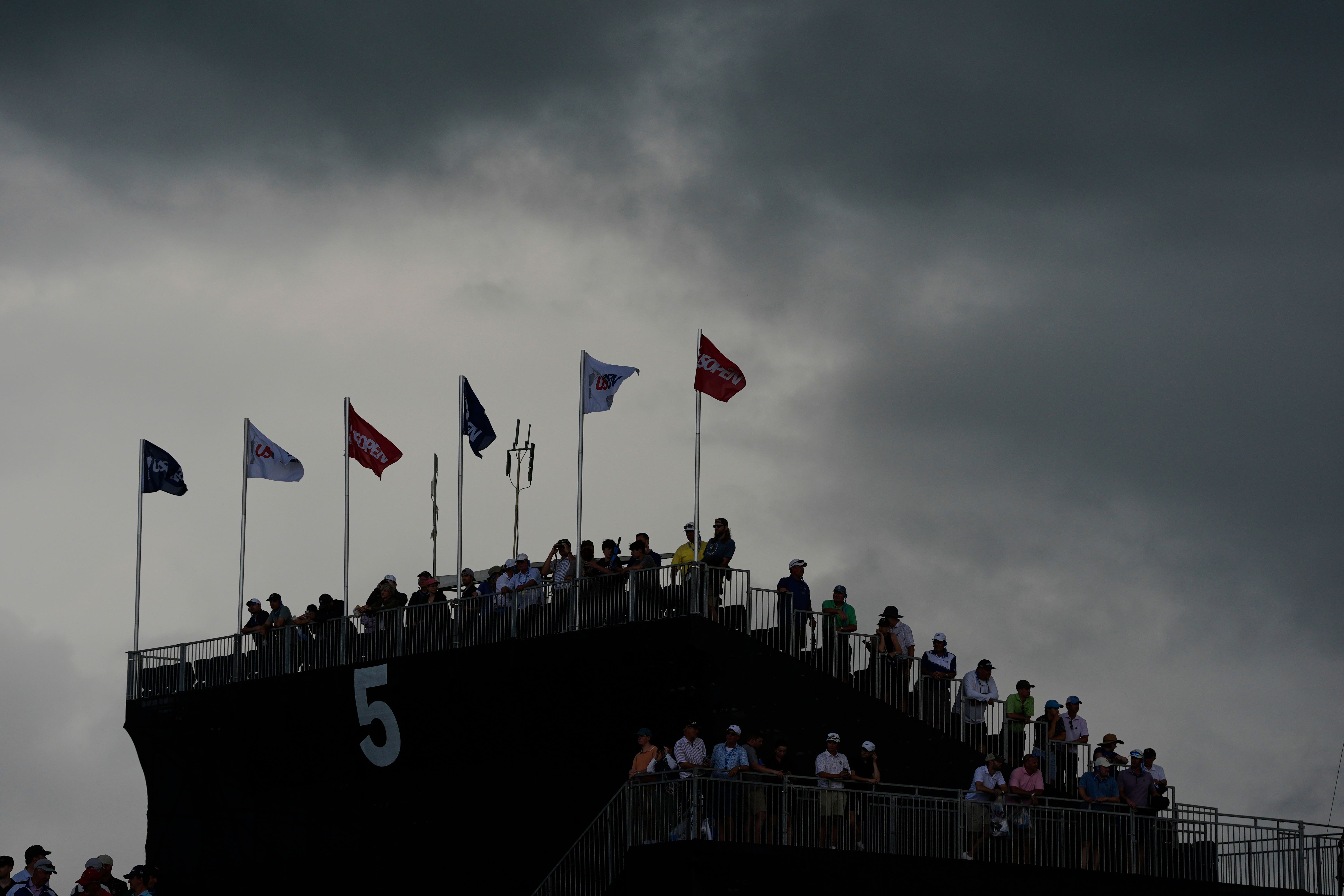 Play was suspended as the heavens opened at Oakmont midway through the final round (Charlie Riedel/AP)