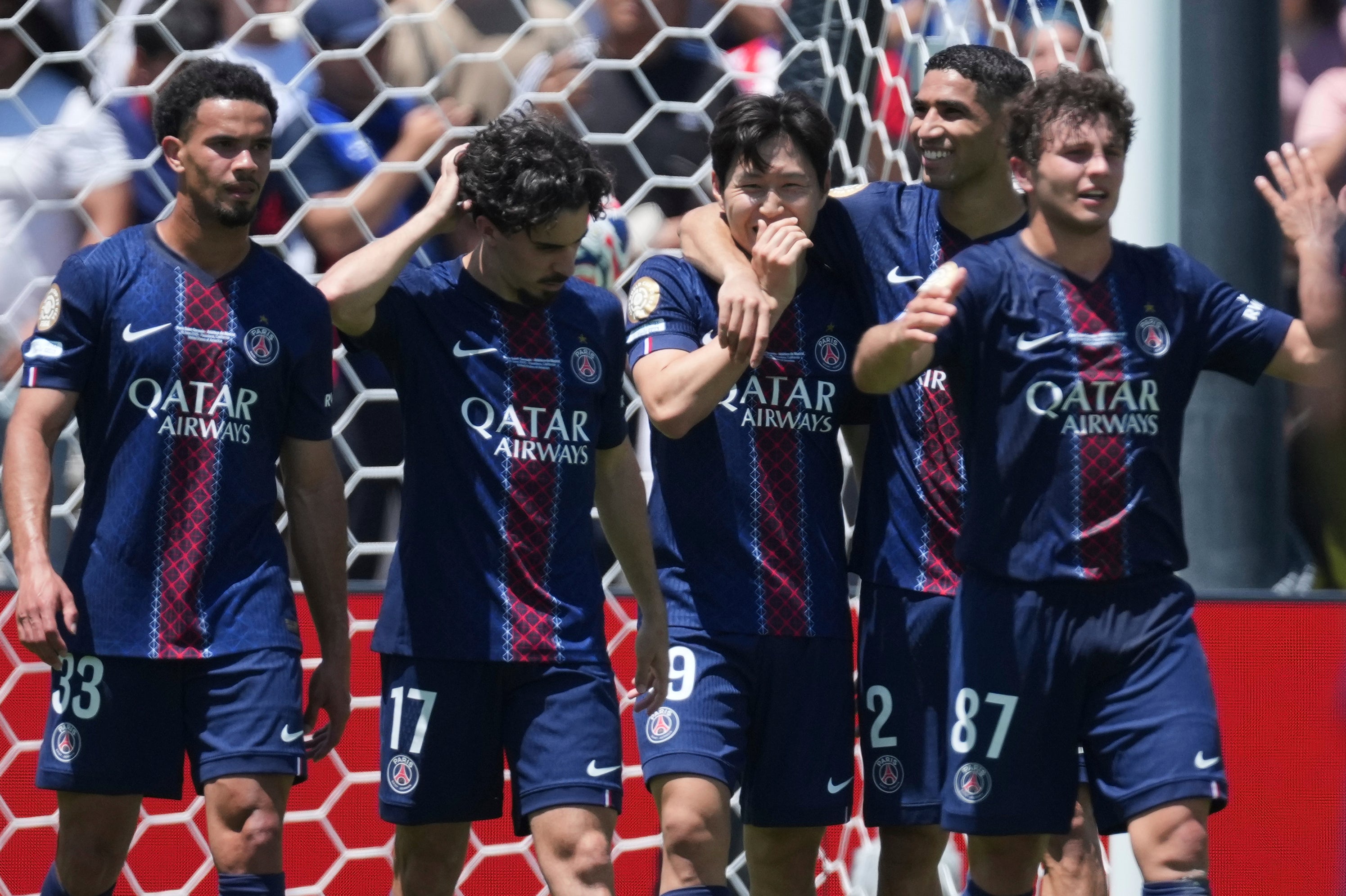 Paris St Germain players celebrate in their opening 4-0 Club World Cup win over Atletico Madrid (Jae Hong/AP)
