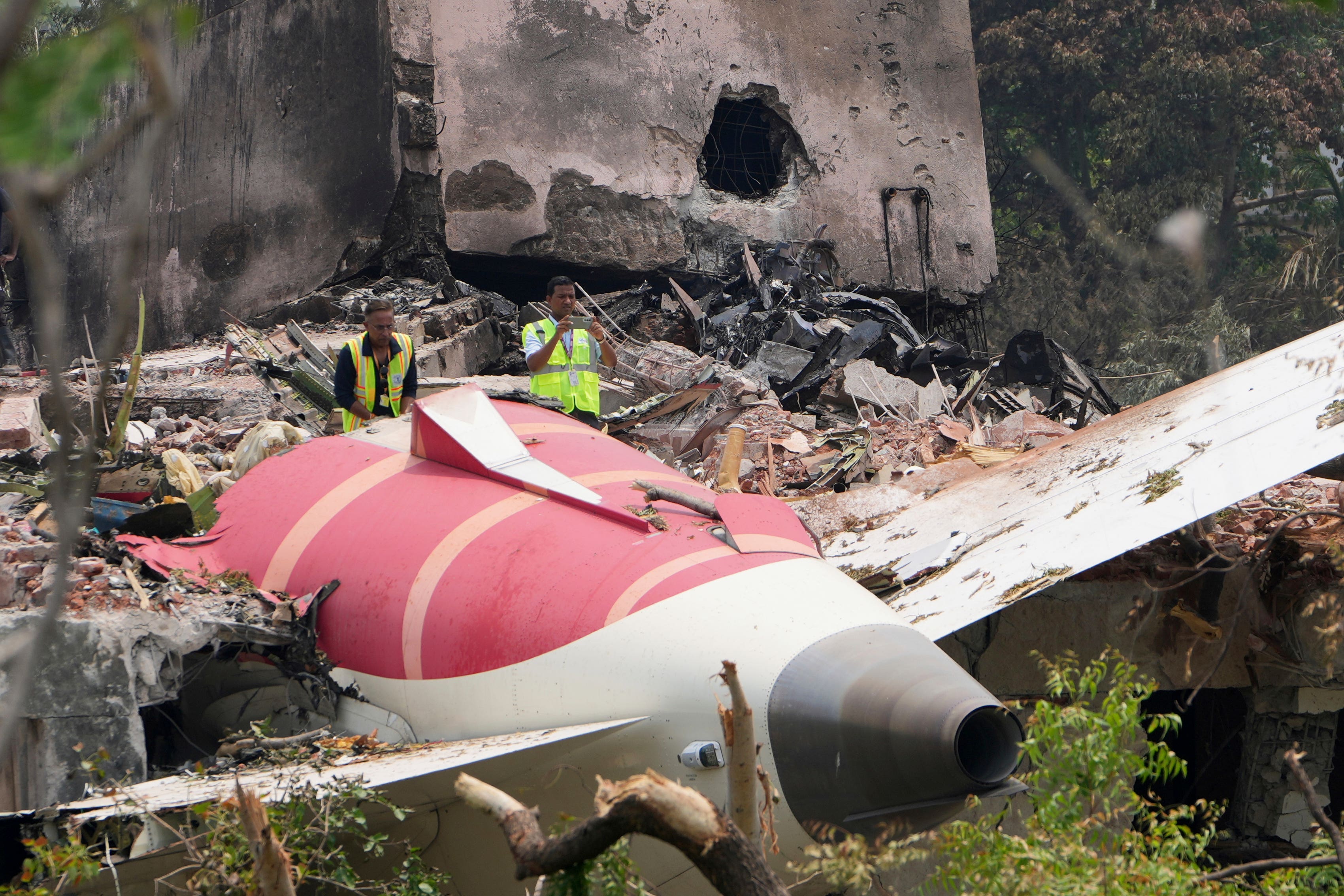 Officials inspect the site of the Air India plane crash