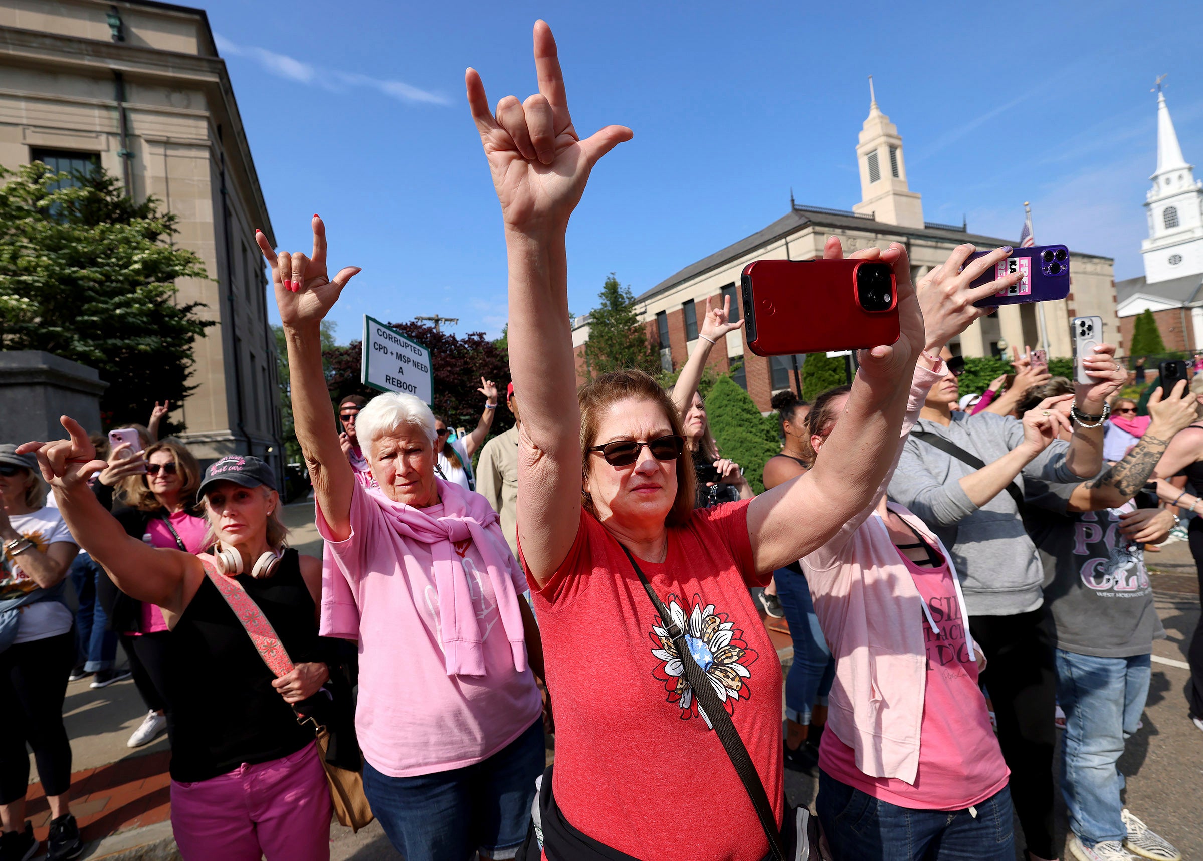 Karen fans read to the days gathered outside the courtroom during the trial