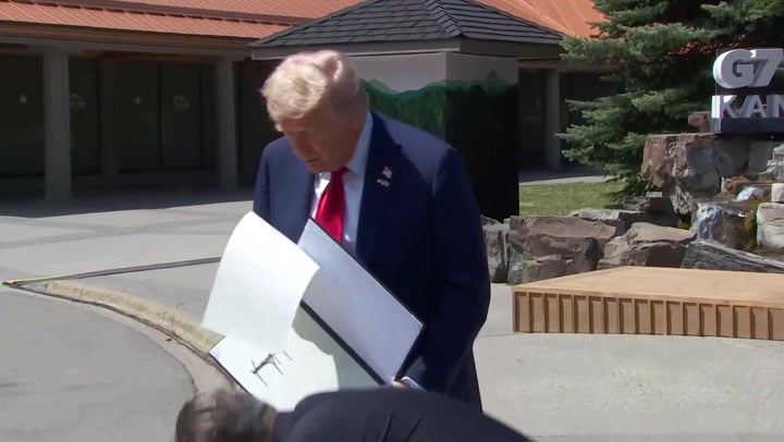 Donald Trump accidentally drops signed US-UK trade deal document