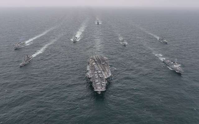<p>The USS Nimitz (center) sails through international waters alongside Japanese and South Korean ships during an exercise in April 2023</p>