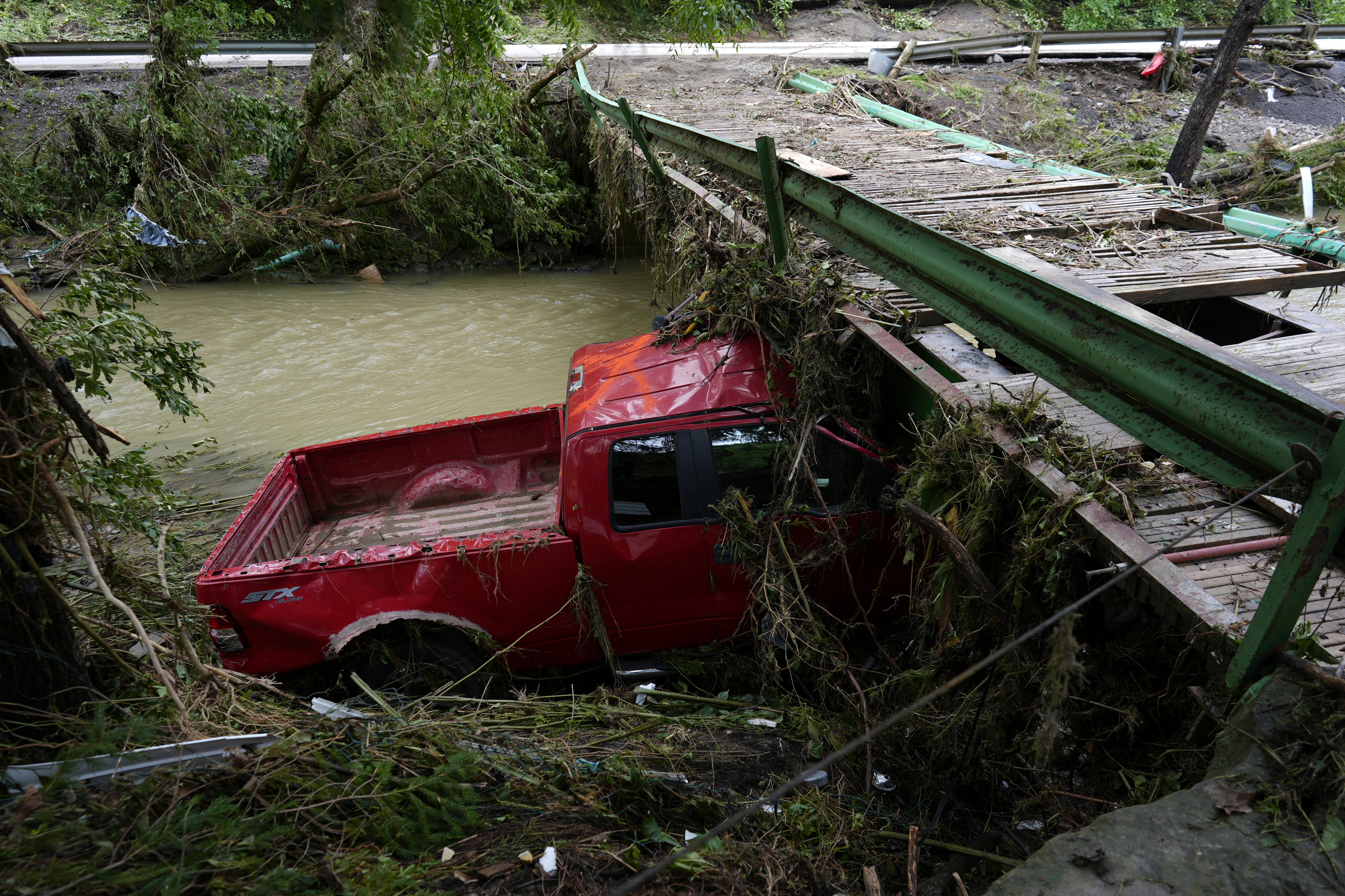 An abandoned vehicle stuck in flood debris in Valley Grove, West Virginia