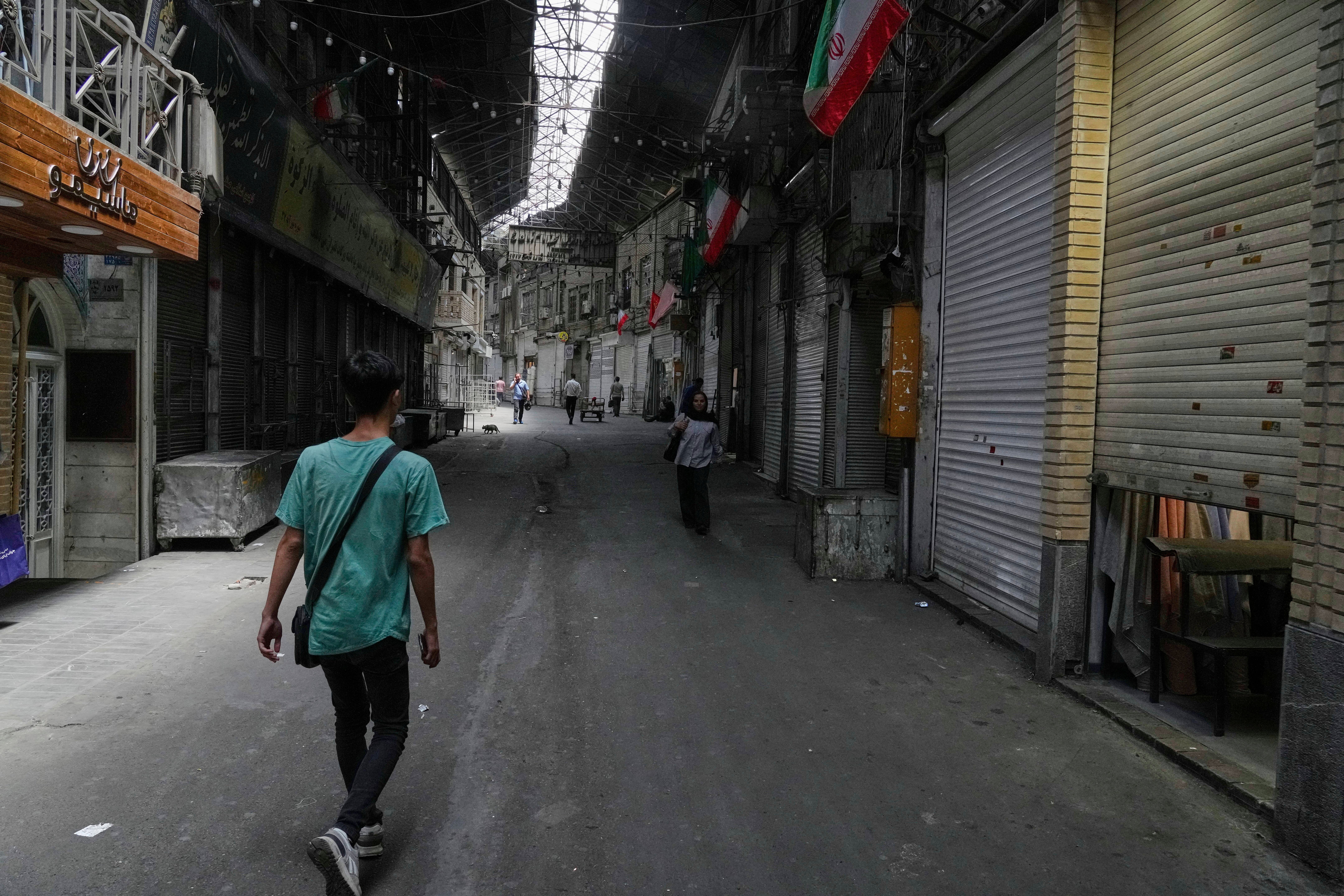 As the sky over Tehran rumbles with anxiety and explosions, shops are eerily silent