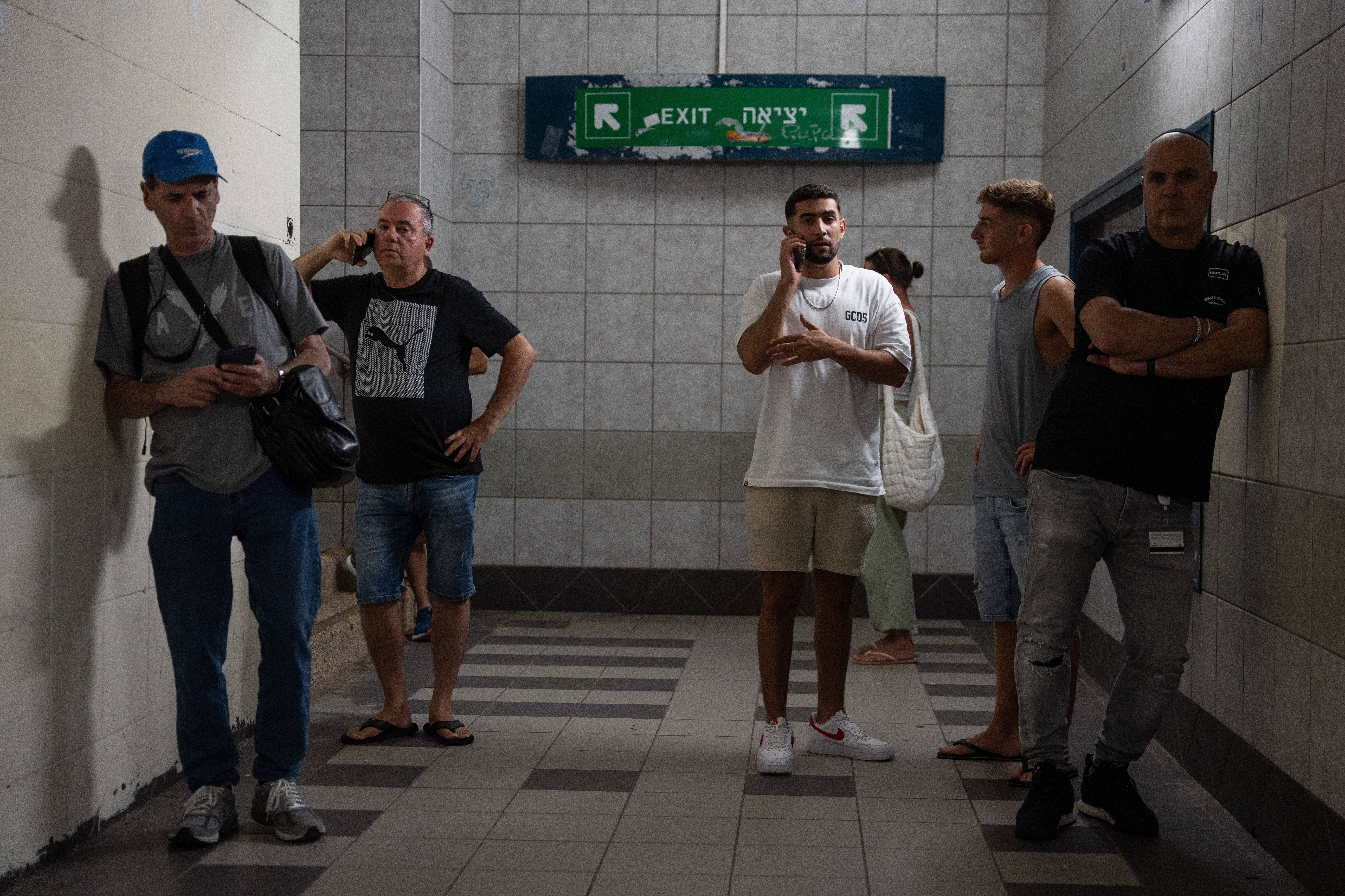 Israelis take shelter during a missile siren alert in Haifa. Ms Baker said her family were forced to take shelter twice on Monday
