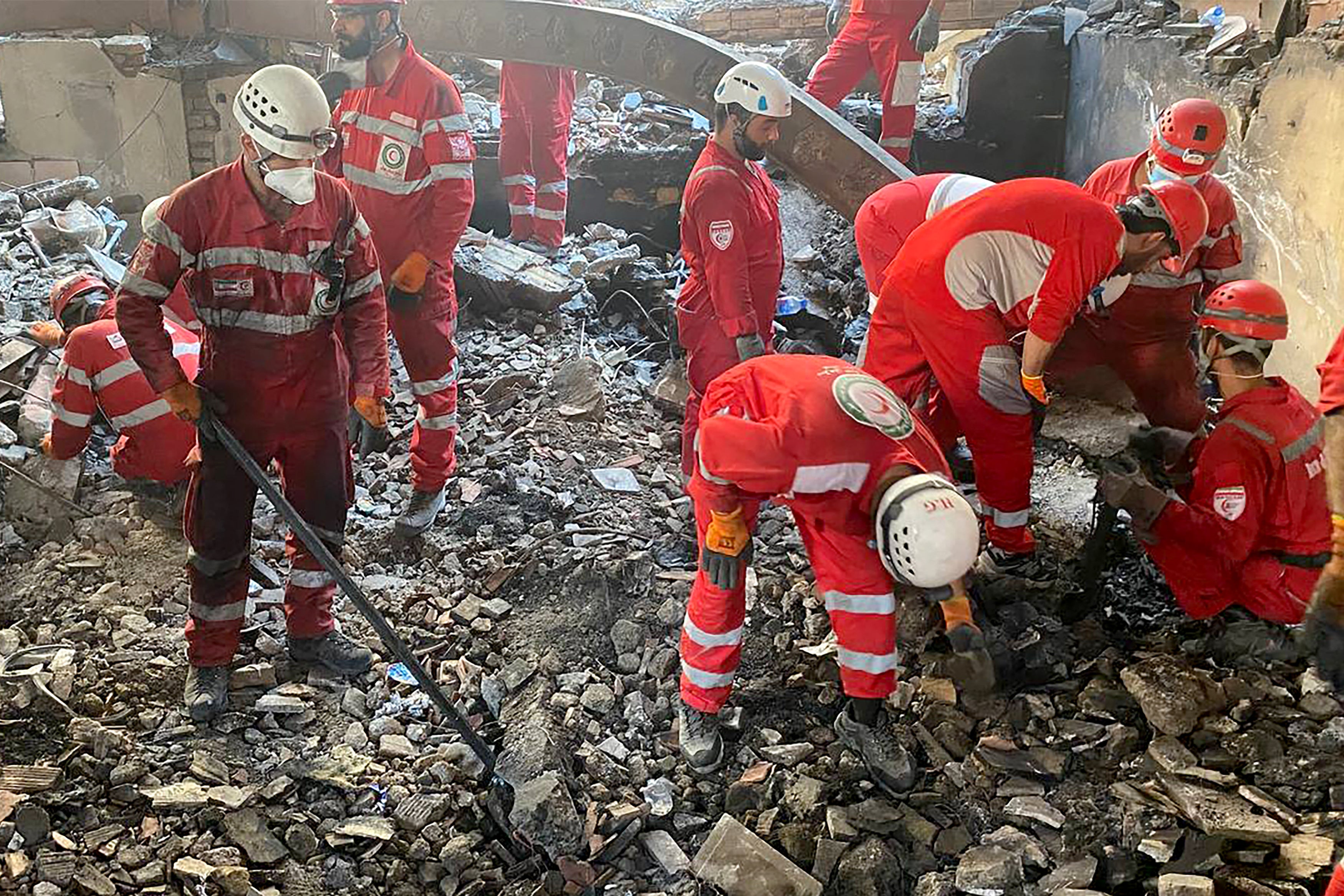 Rescue teams searching the debris inside a buidling in Tehran, targeted by Israeli strikes