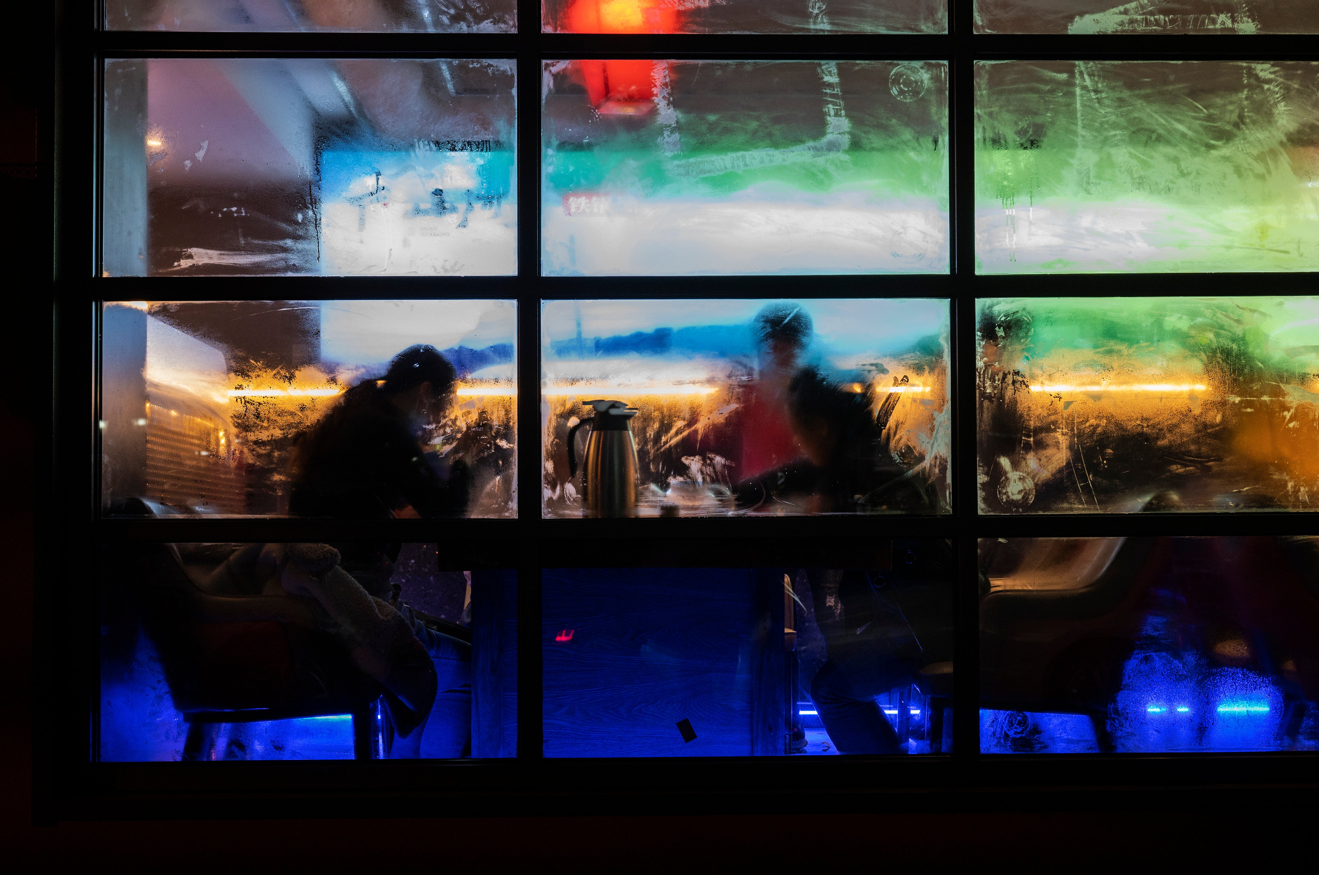 Steam is seen on the windows as staff sit for a meal at a restaurant that was closed for inside dining in Beijing, China