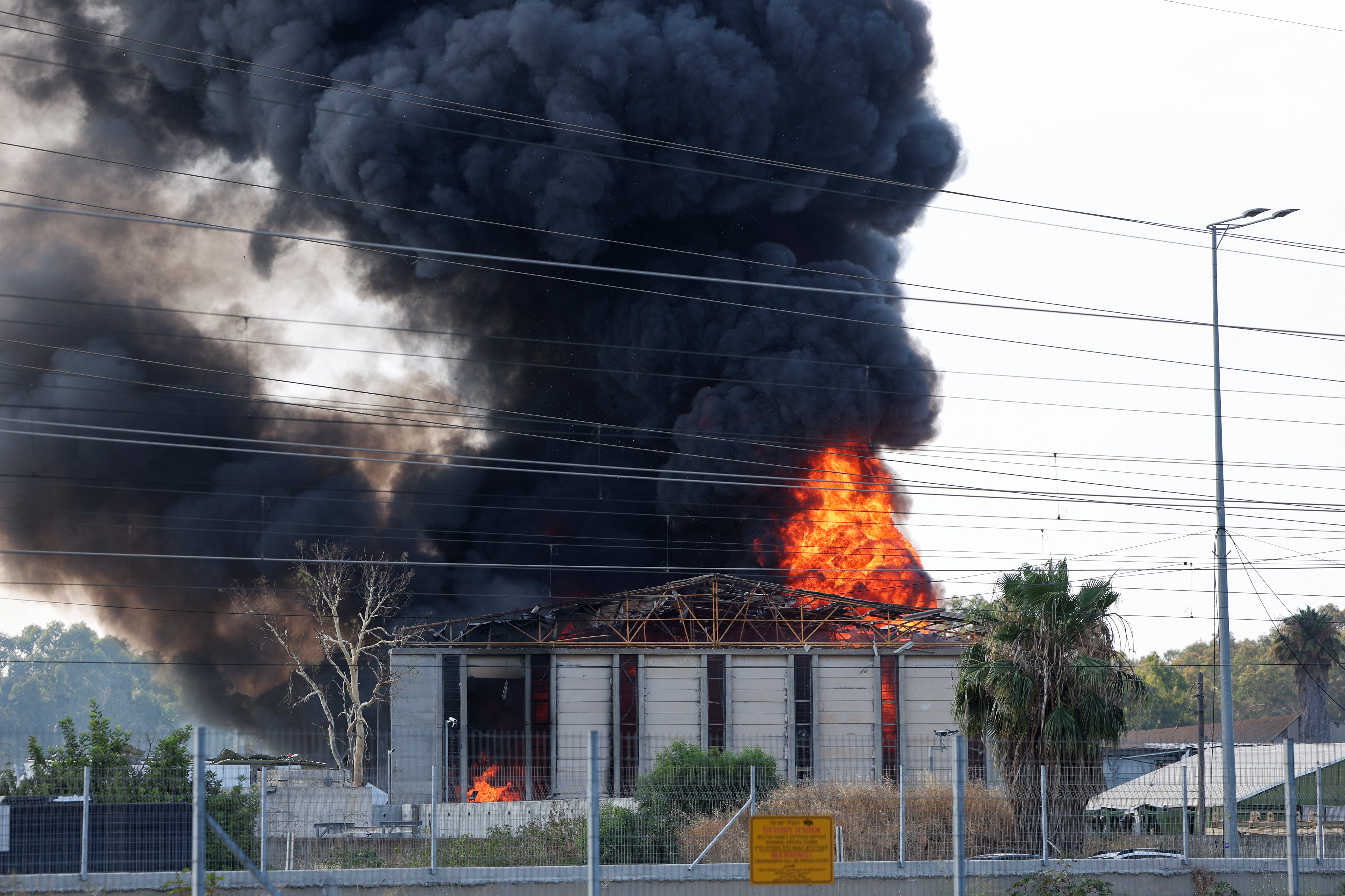 Smoke billows from a fire in a building in Herzliya near Tel Aviv following a fresh barrage of Iranian rockets on Tuesday