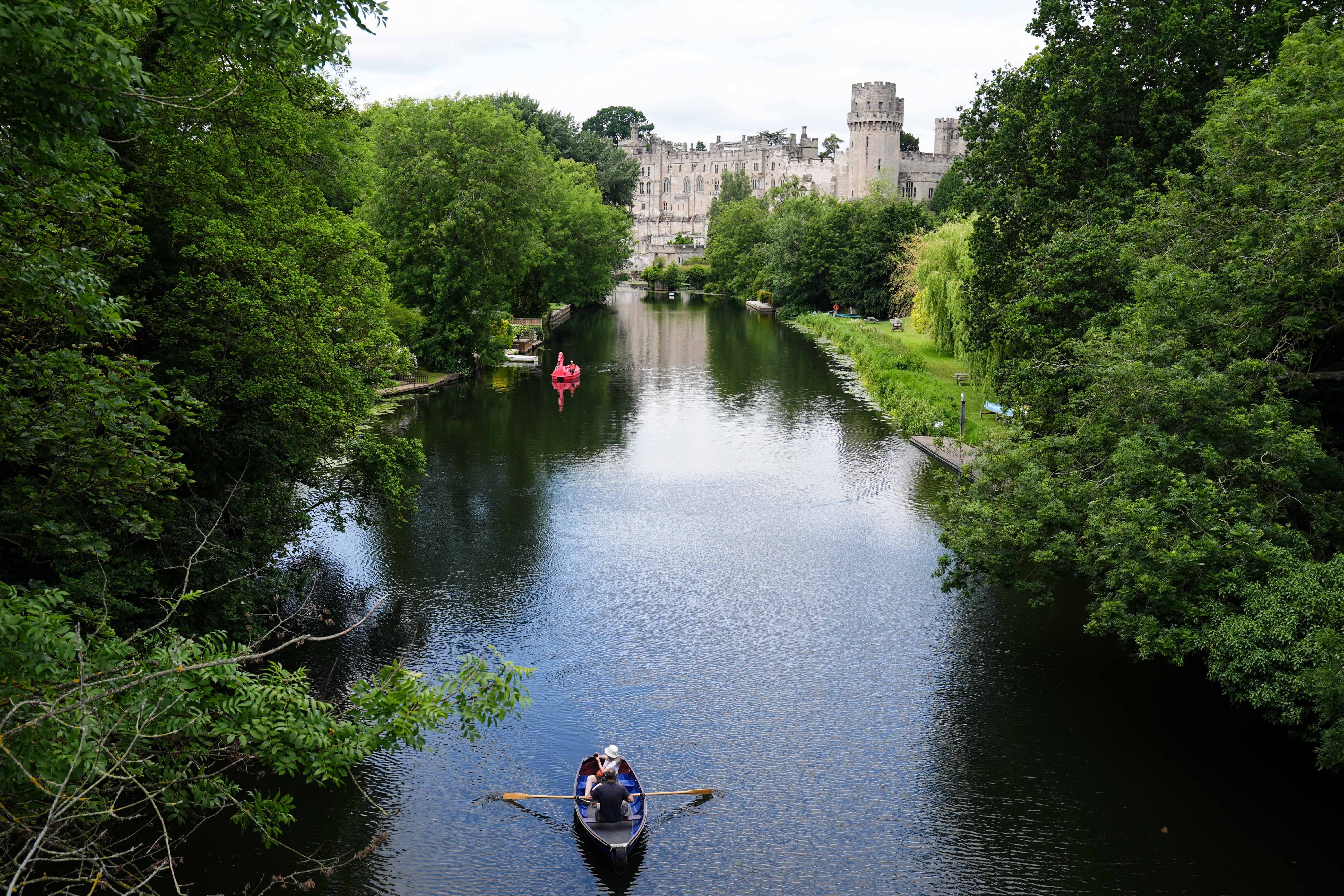 People use boats on the river Avon by Warwick Castle (Jacob King/PA)