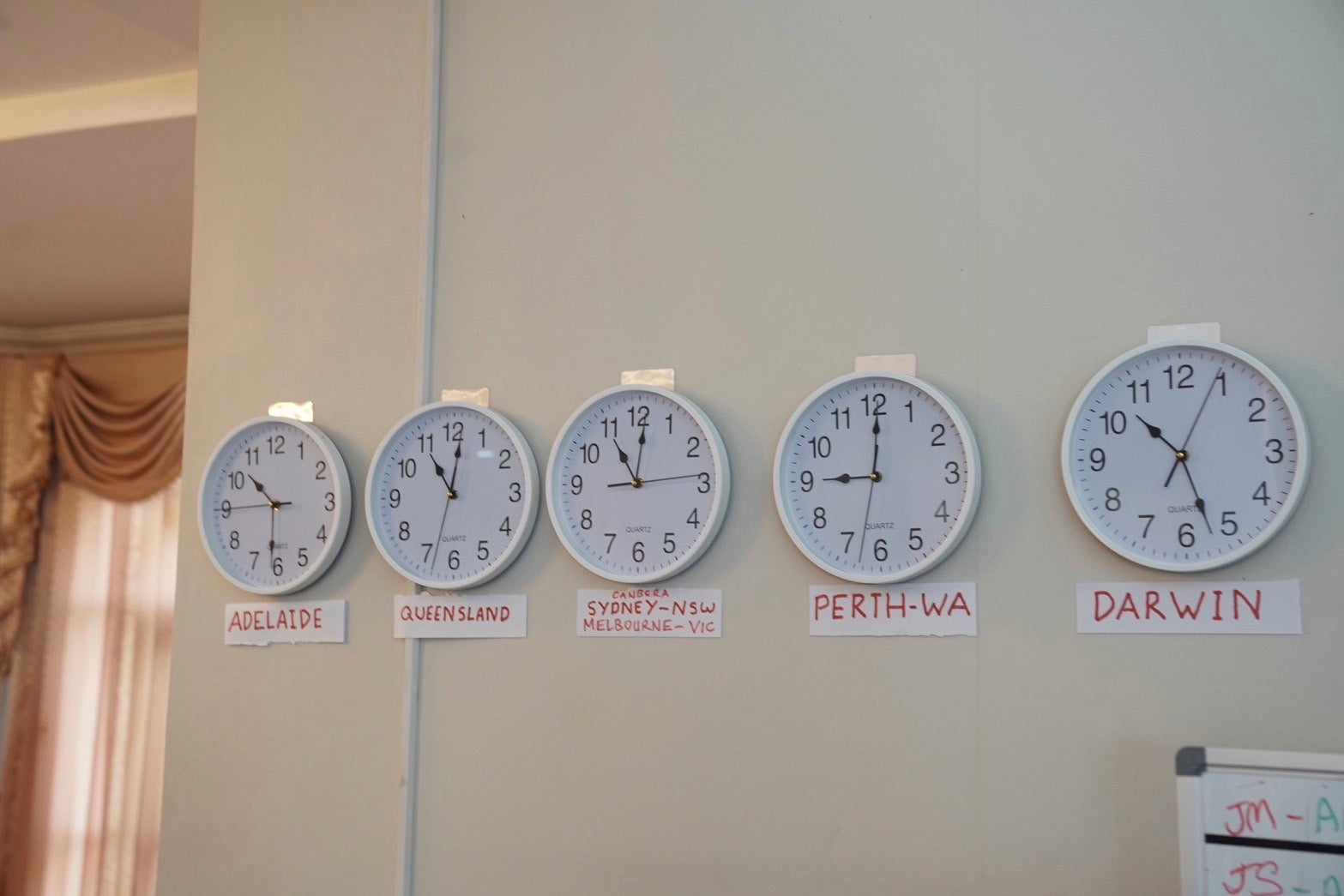 Clocks with different Australia's time zones are displayed at a rental house where an online investment fraud targeting Australians was allegedly being run.
