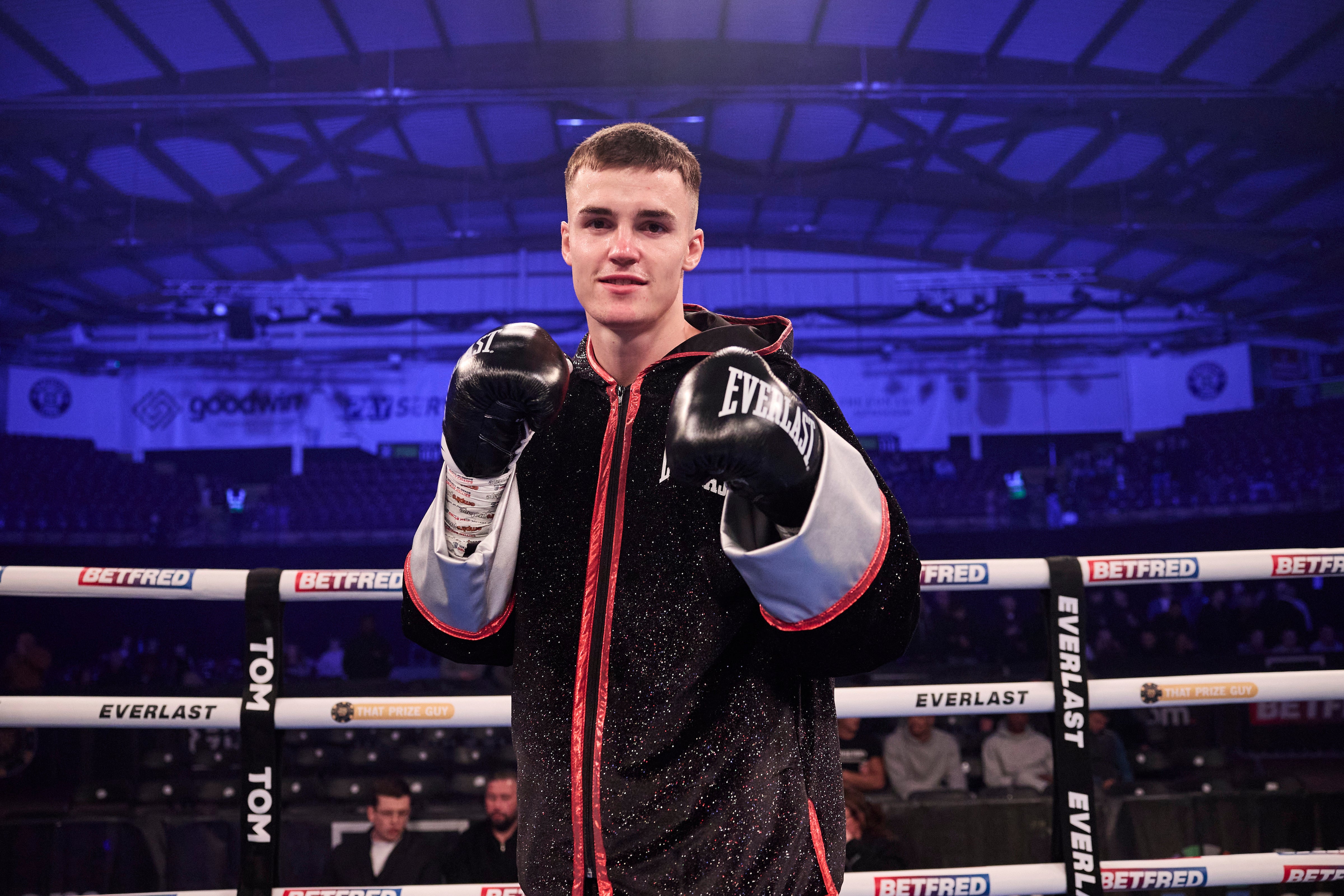 Taylor Bevan stands with his fists raised after defeating Ales Makovec in the first round