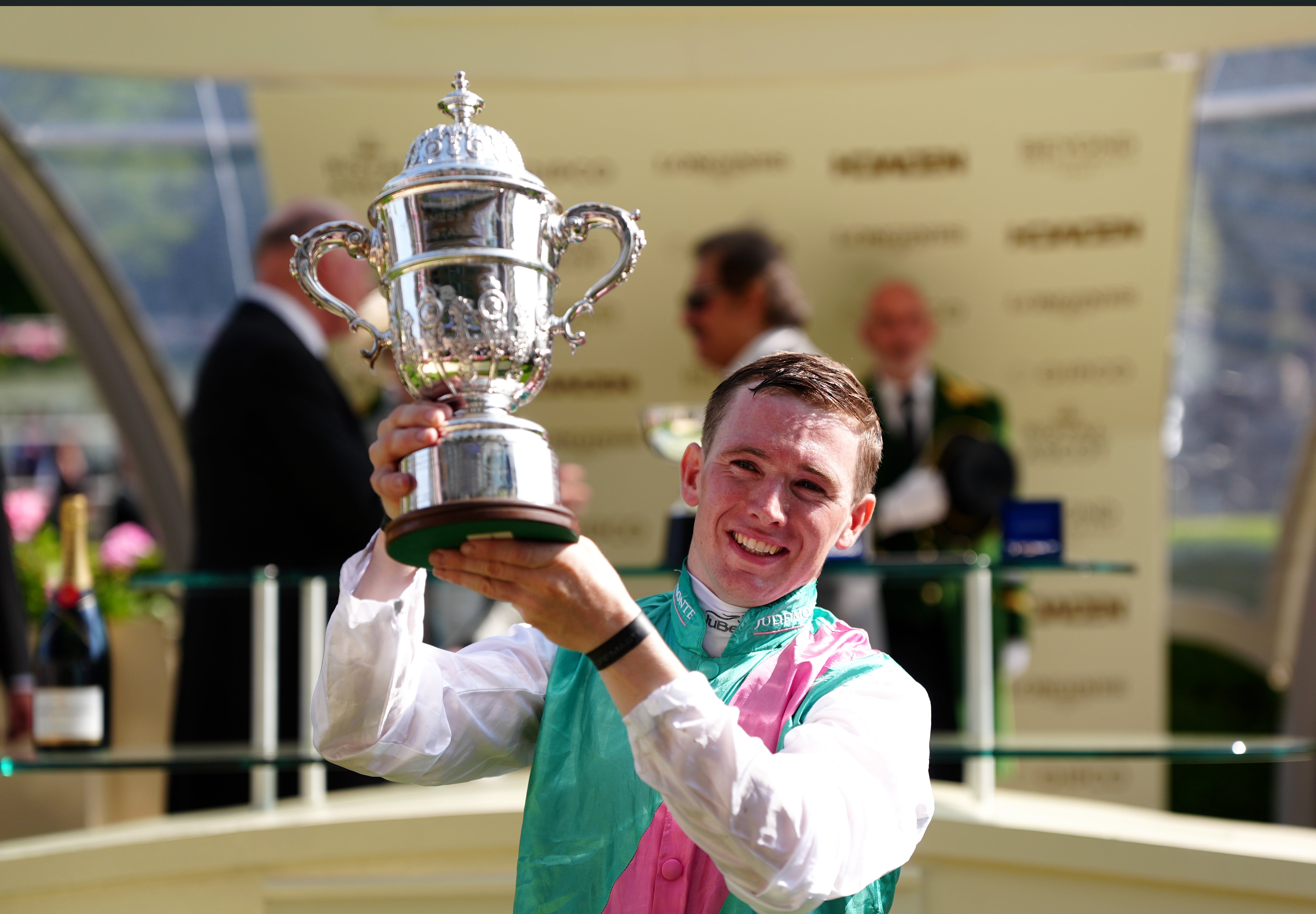 Jockey Colin Keane lits the trophy after winning atop Field Of Gold