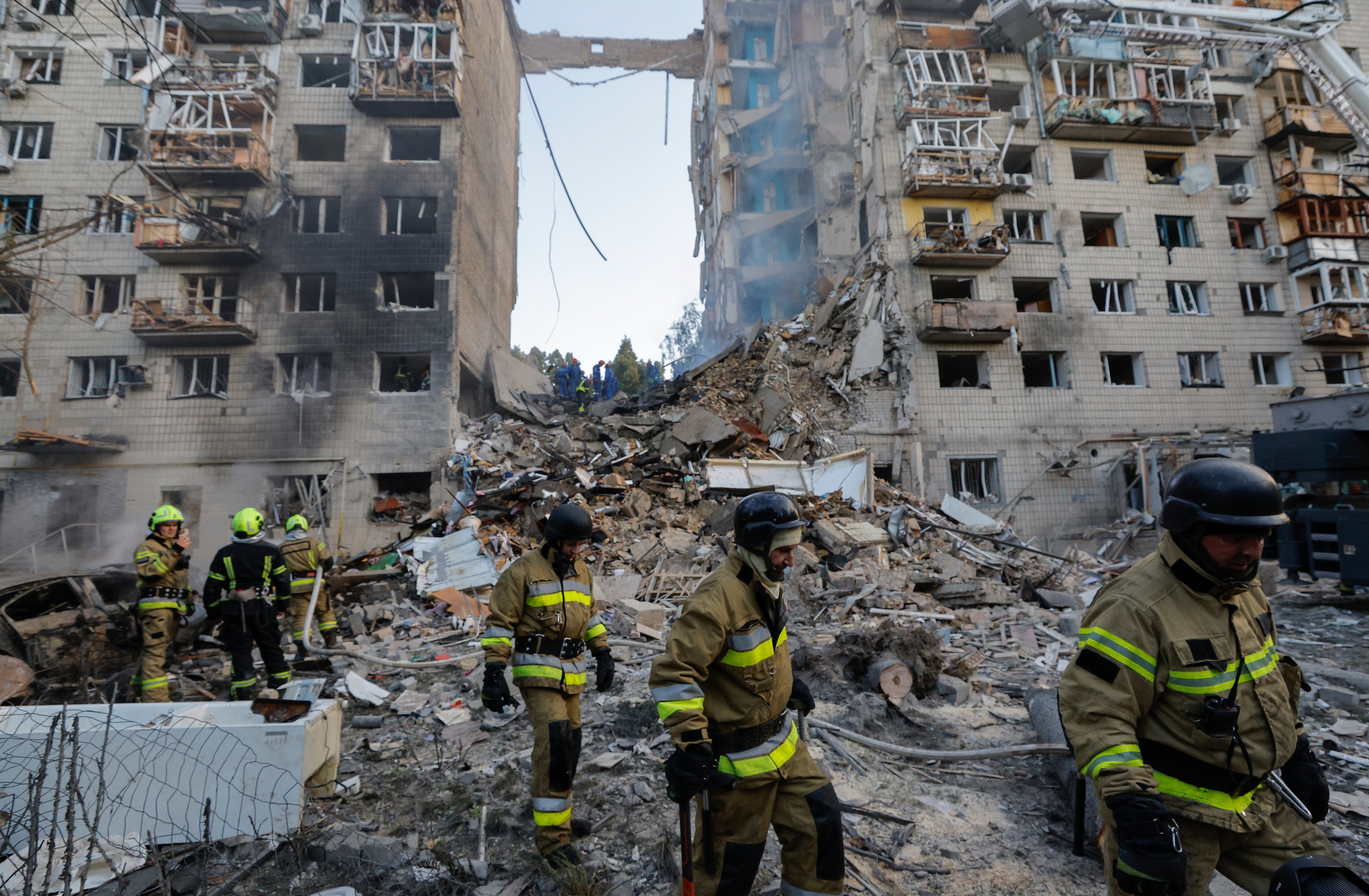 Rescuers work at the site of an airstrike in Kyiv