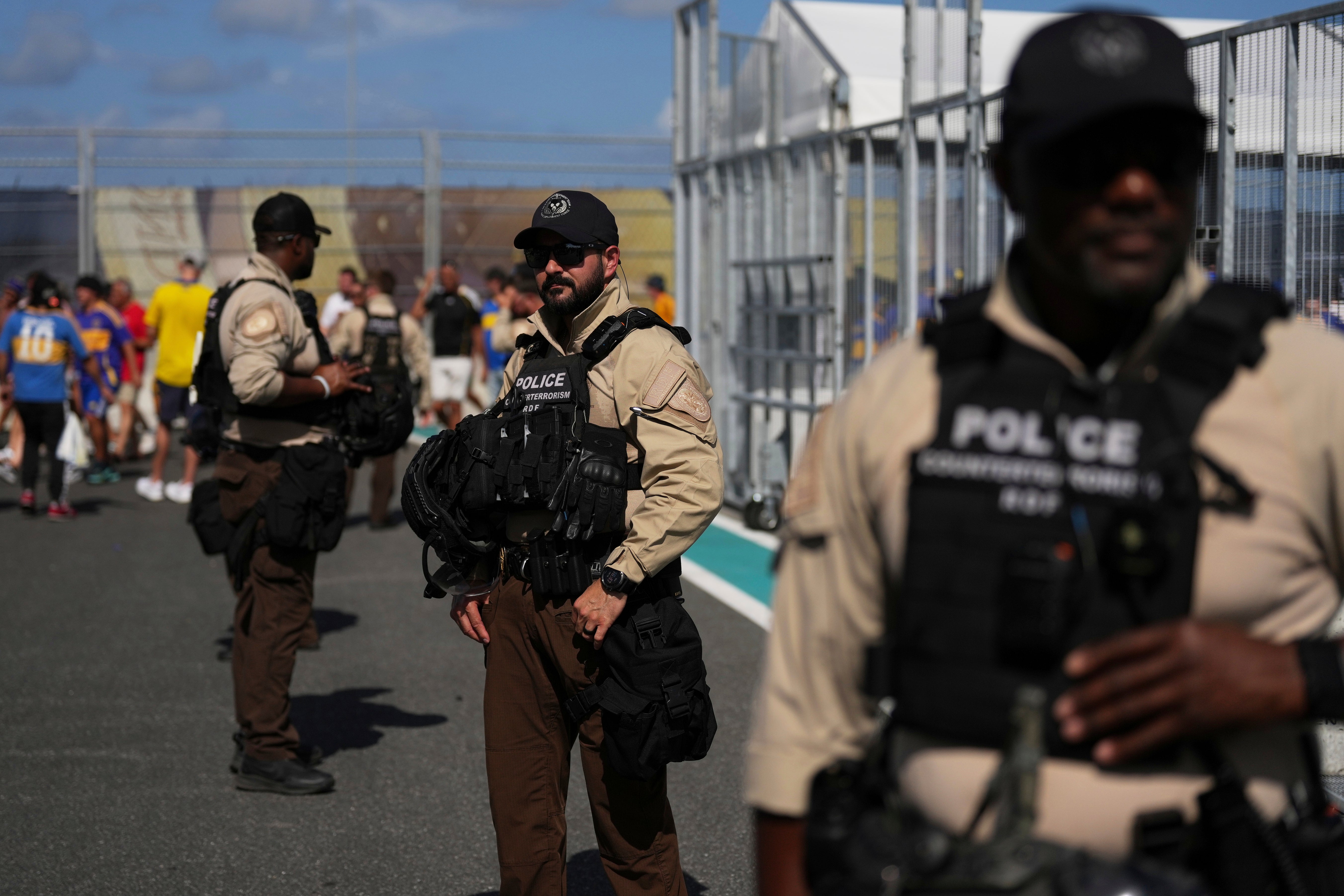 Law enforcement personnel stand outside the stadium prior to the Club World Cup group C soccer match between Boca Juniors and Benfica in Miami Gardens