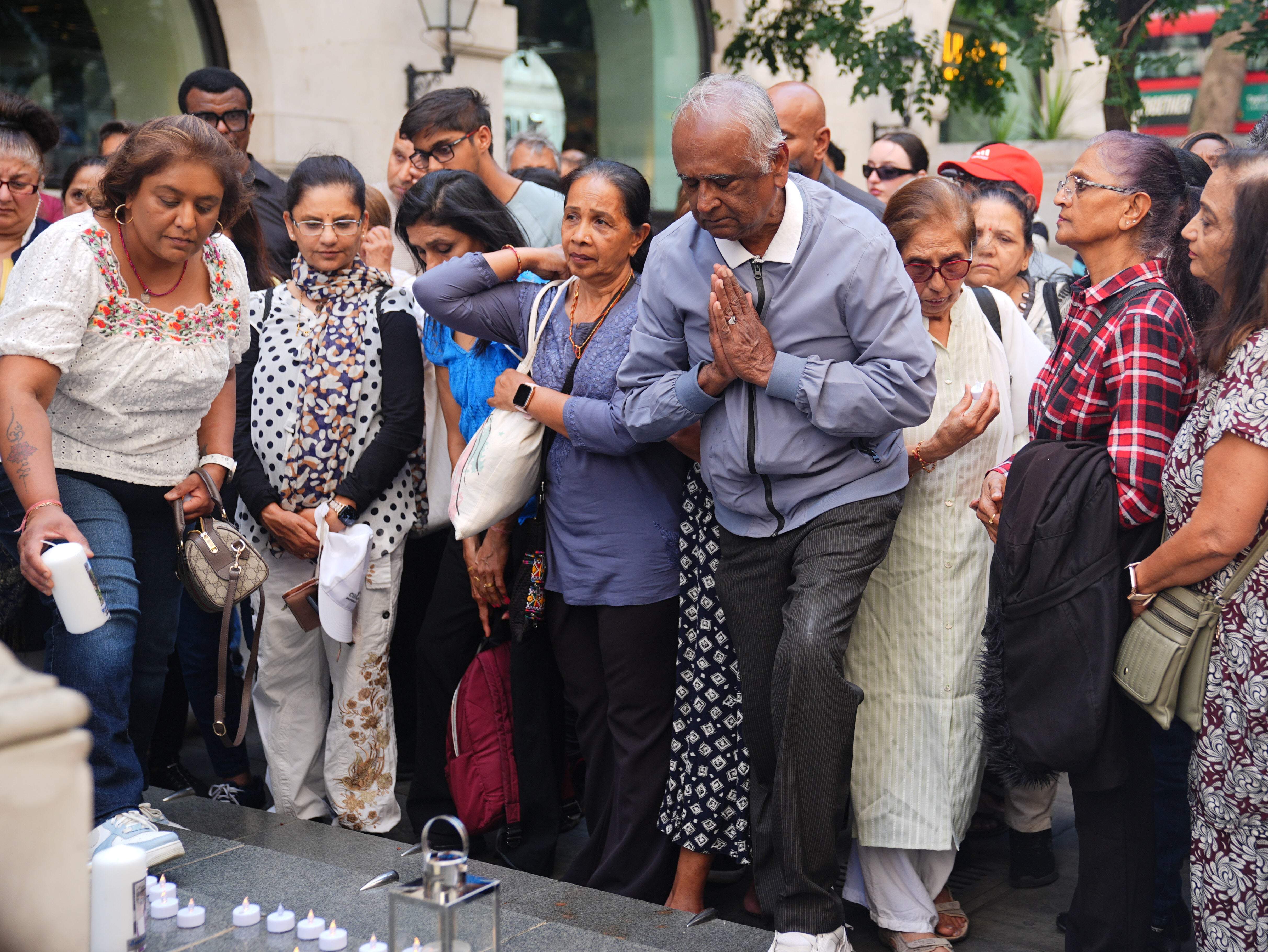 People attend a candlelight vigil outside the High Commission of India, India House in London, to honour the victims of the Air India crash.