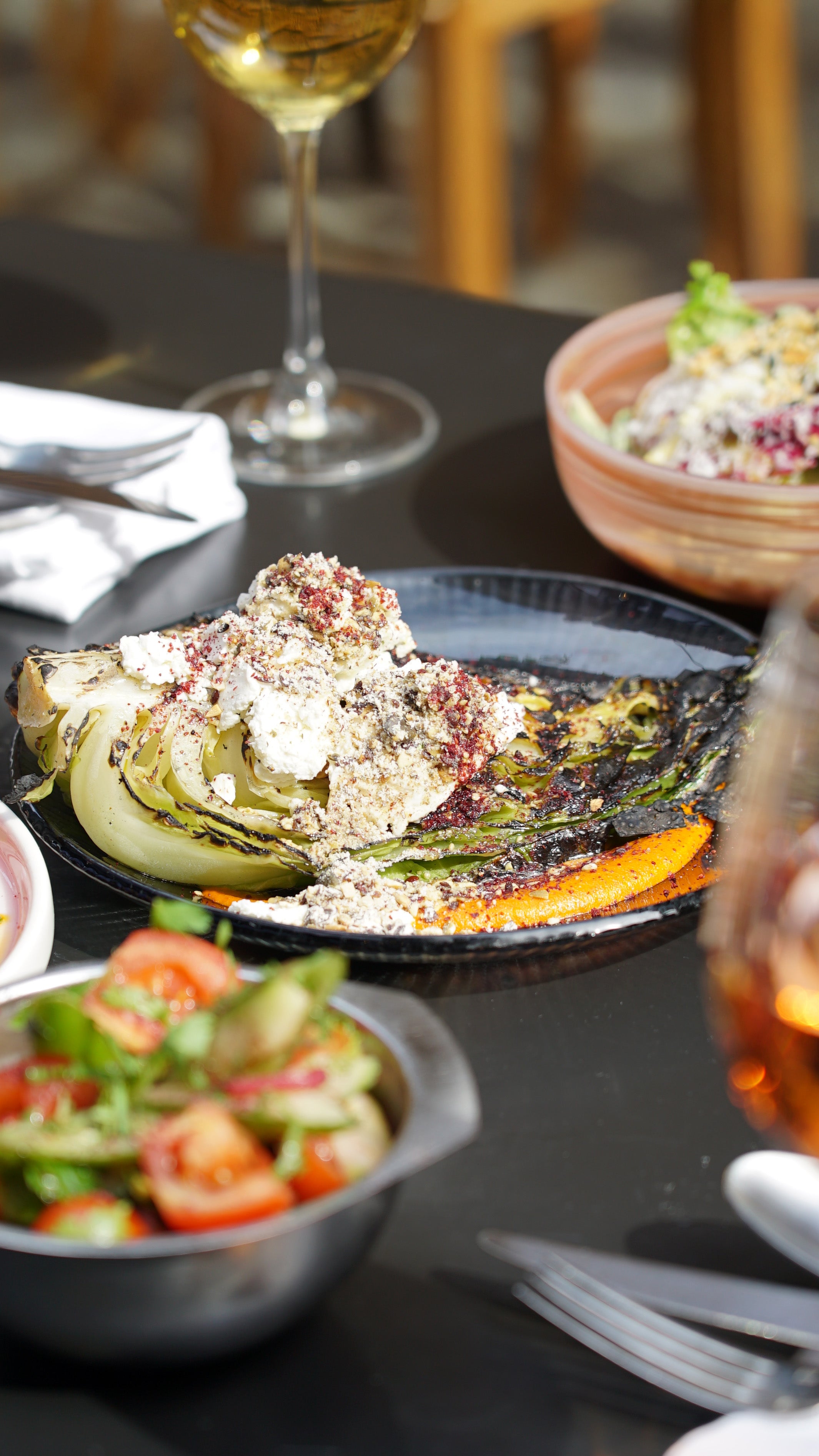Smoky hispi cabbage with romesco sauce and crunchy seed crumble