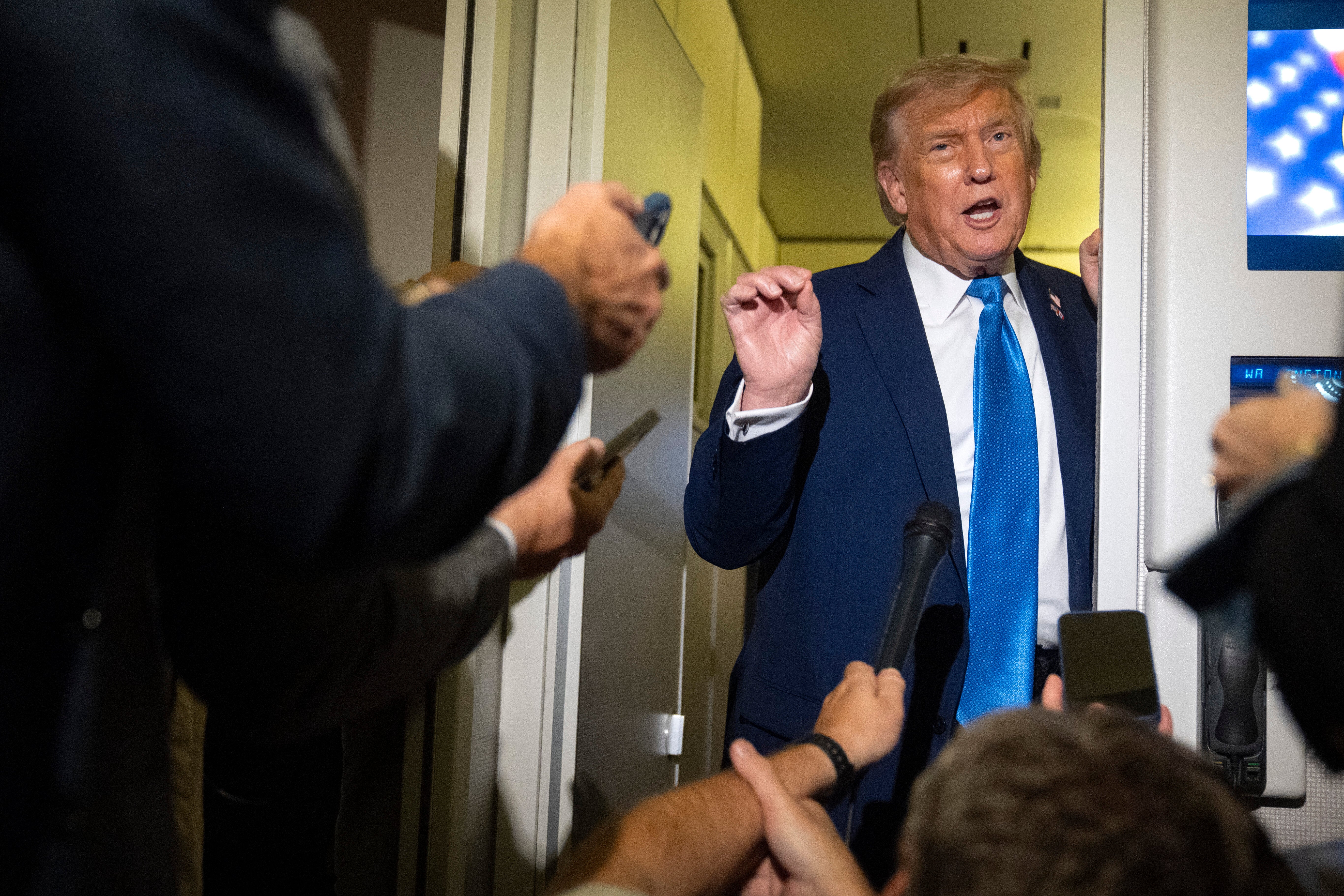 President Trump speaks to reporters aboard Air Force One after leaving the Group of Seven summit early on Monday