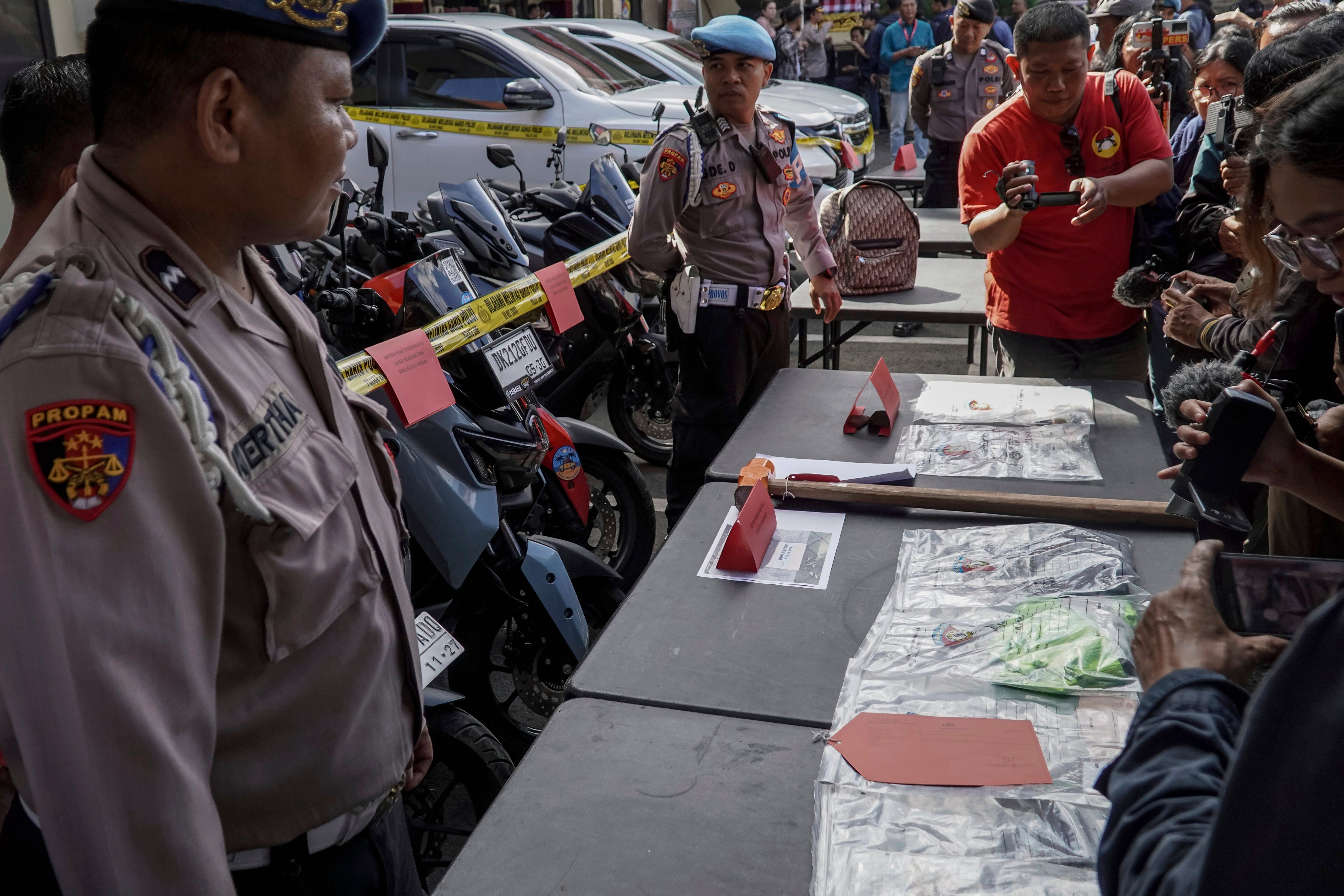 Police officers display evidence related to the fatal shooting of an Australian tourist during a press conference at the local police precinct in Badung, Bali, Indonesia, June 18, 2025. (AP Photo/Herdyanto)