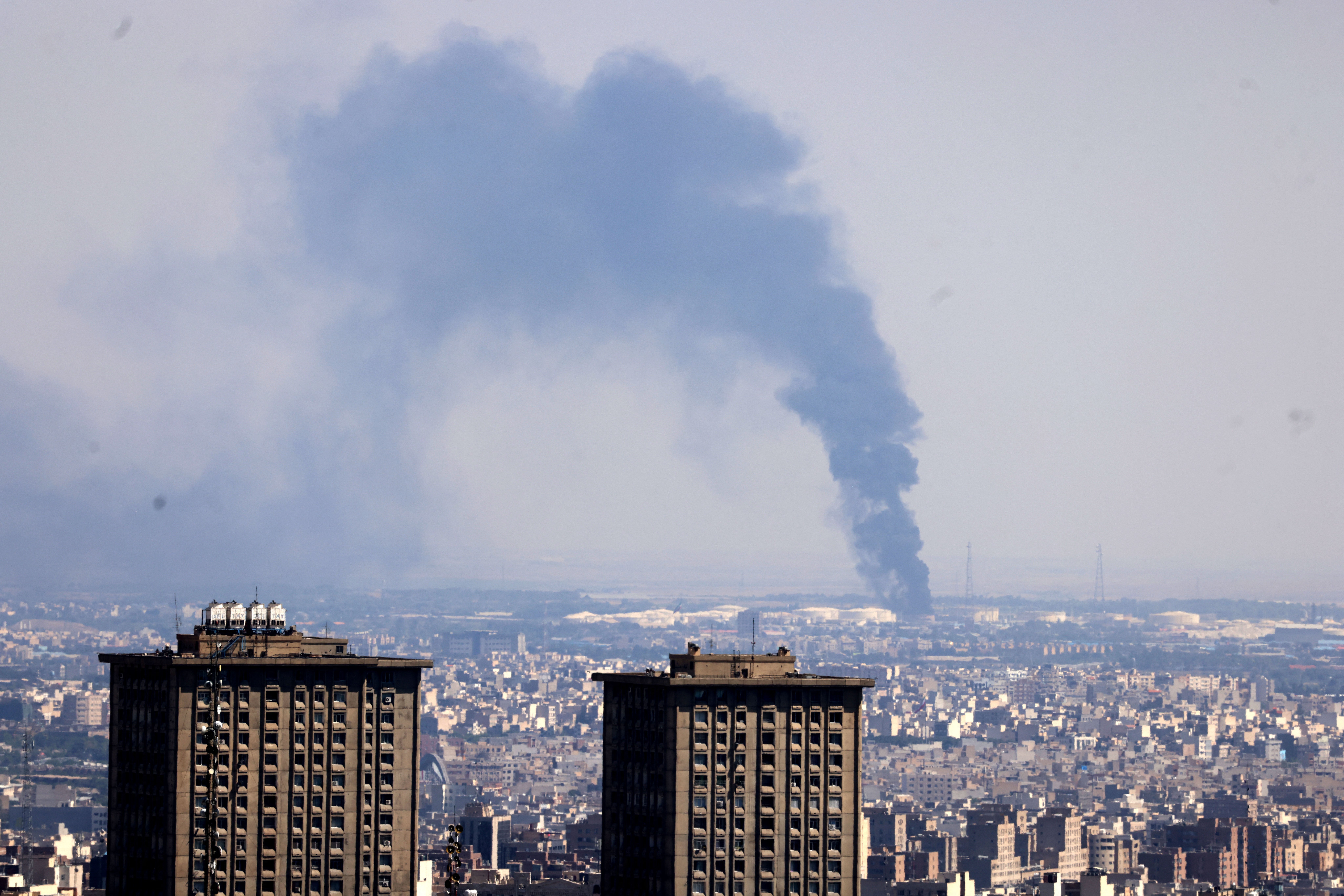 Smoke billows from an oil refinery following an Israeli strike on Tehran