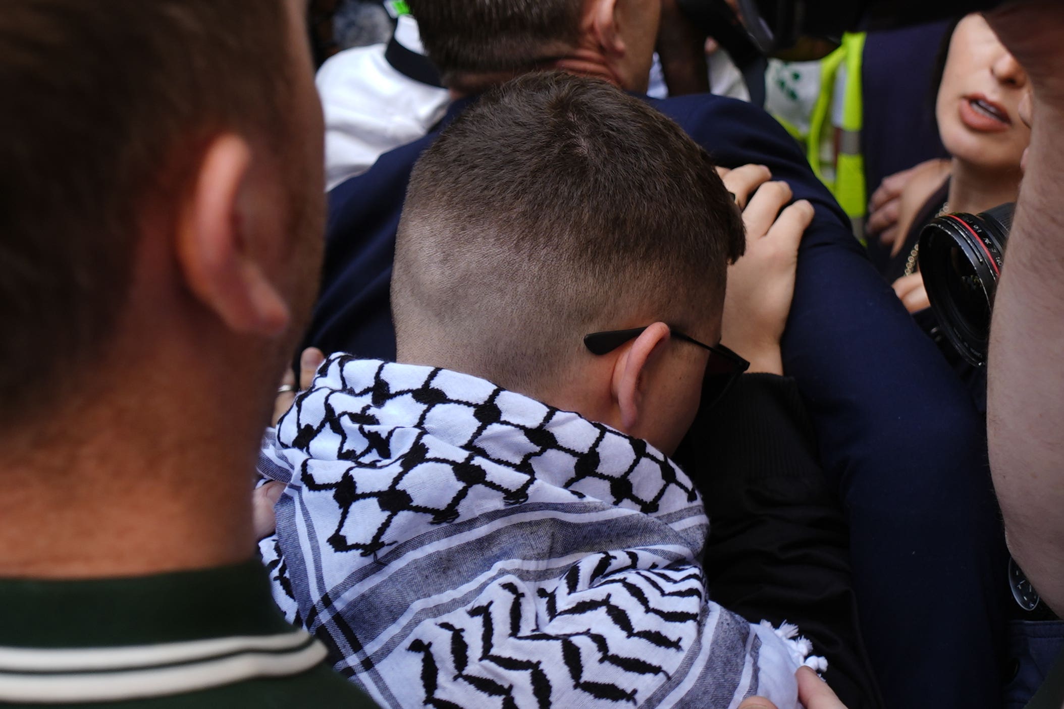 Kneecap’s Liam Og O Hannaidh (centre, in scarf) arrives at Westminster Magistrates’ Court (Jordan Pettitt/PA)