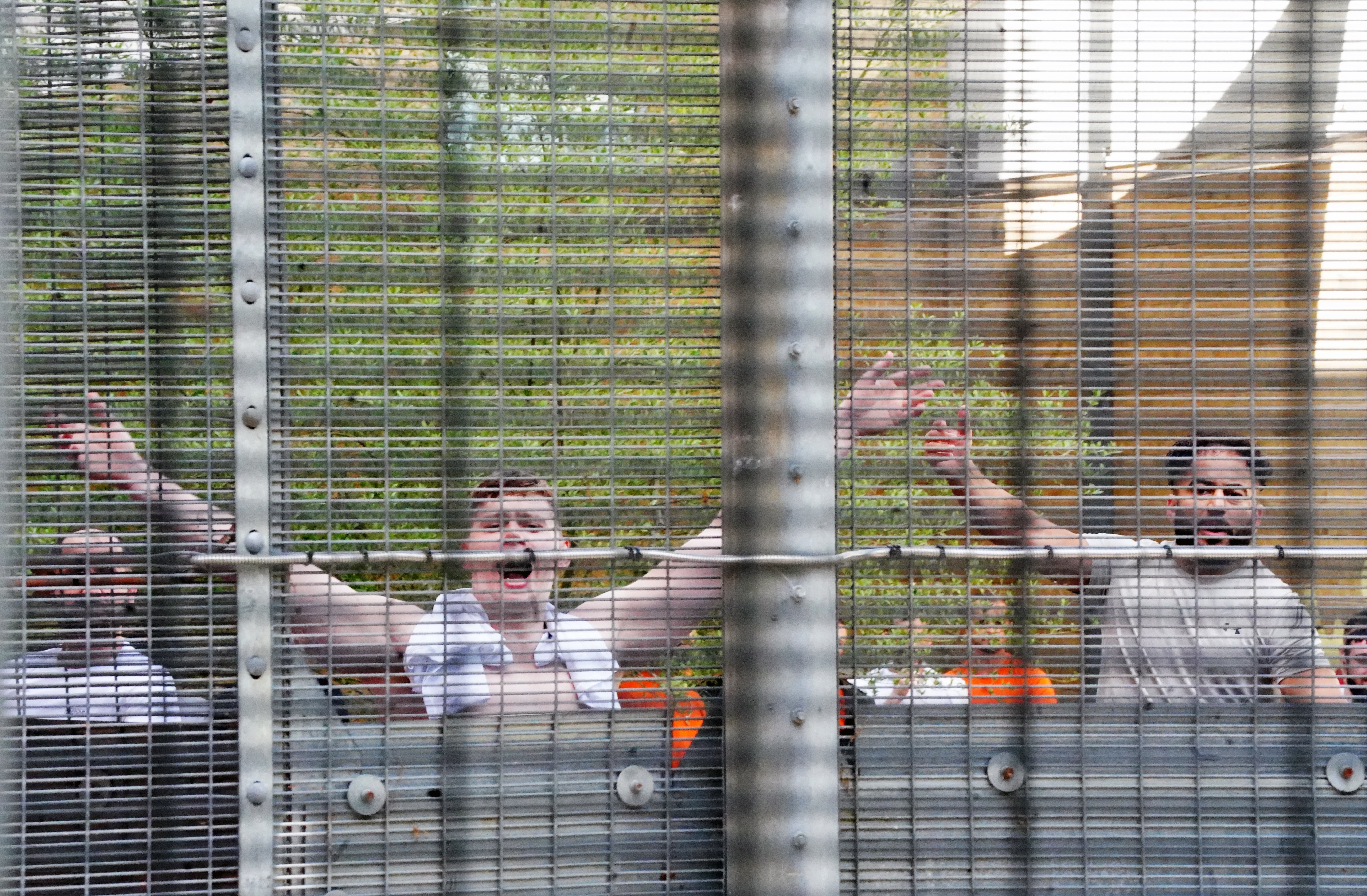 People held at Brook House Immigration Removal Centre at Gatwick respond to demonstrators from migrants rights groups protesting against plans to send migrants to Rwanda.