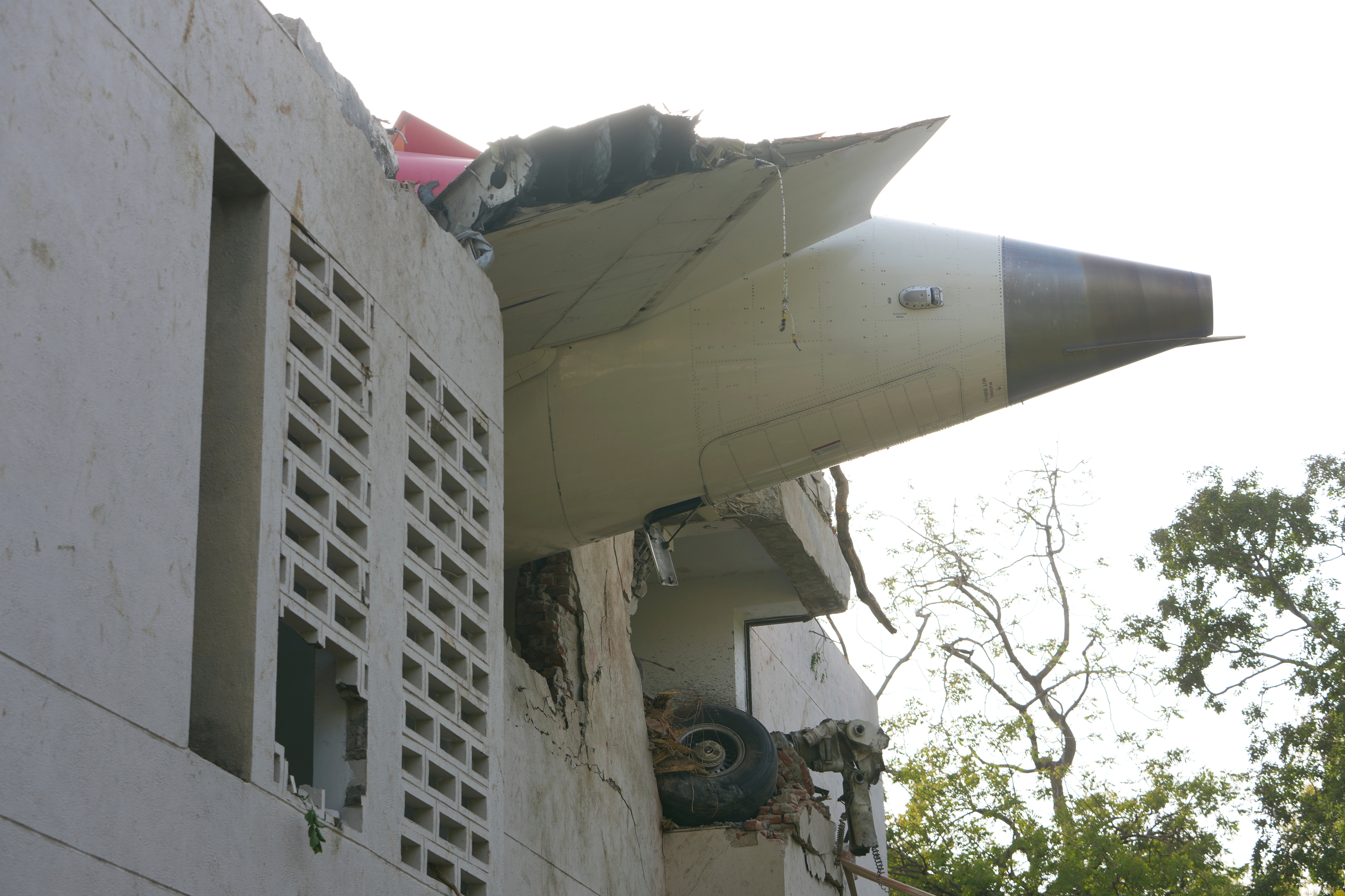 The debris of an airplane sticks out of a building after it crashed in India's northwestern city of Ahmedabad