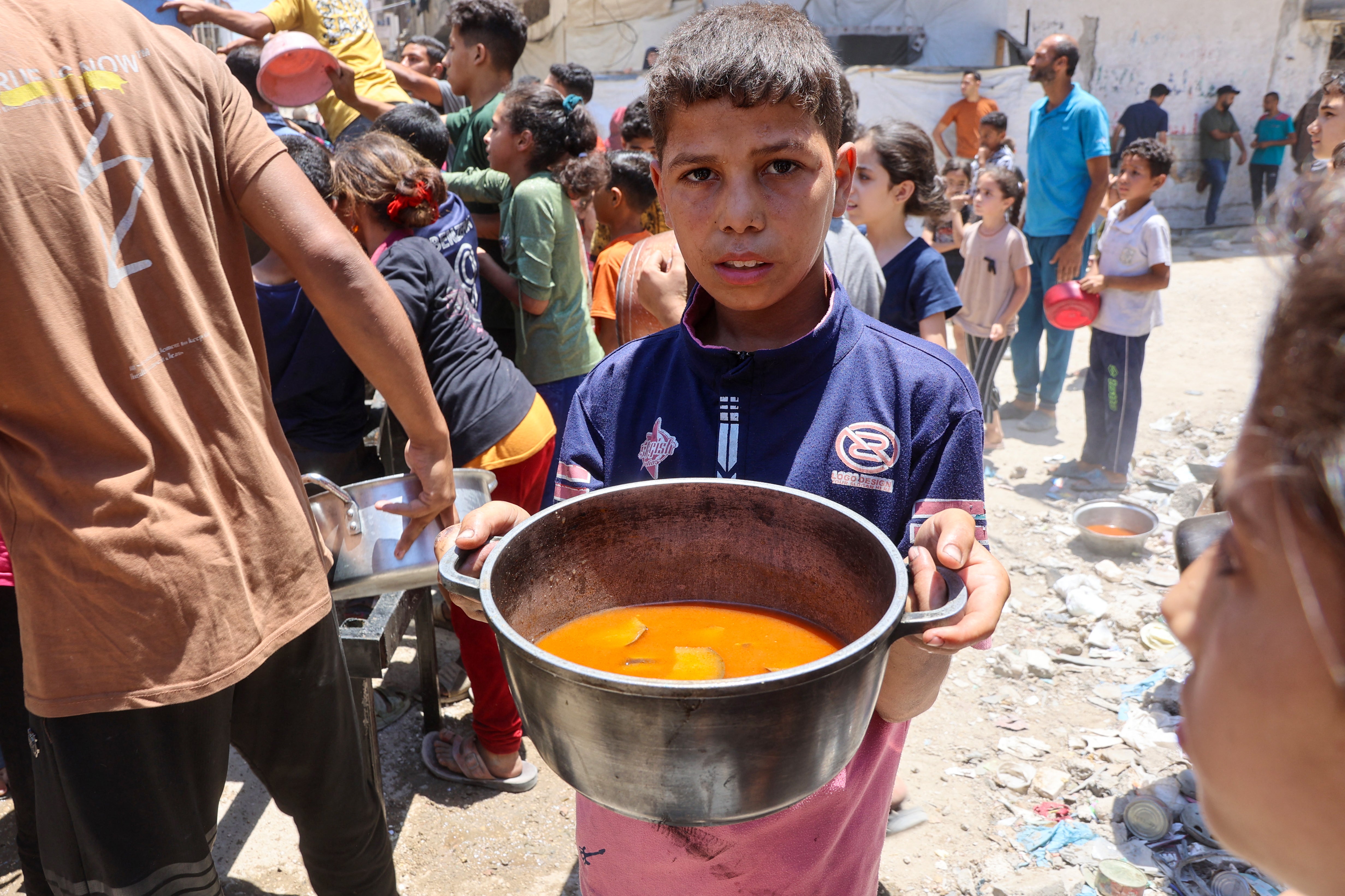 A boy carries a pot at a charity kitchen in Gaza City on Wednesday