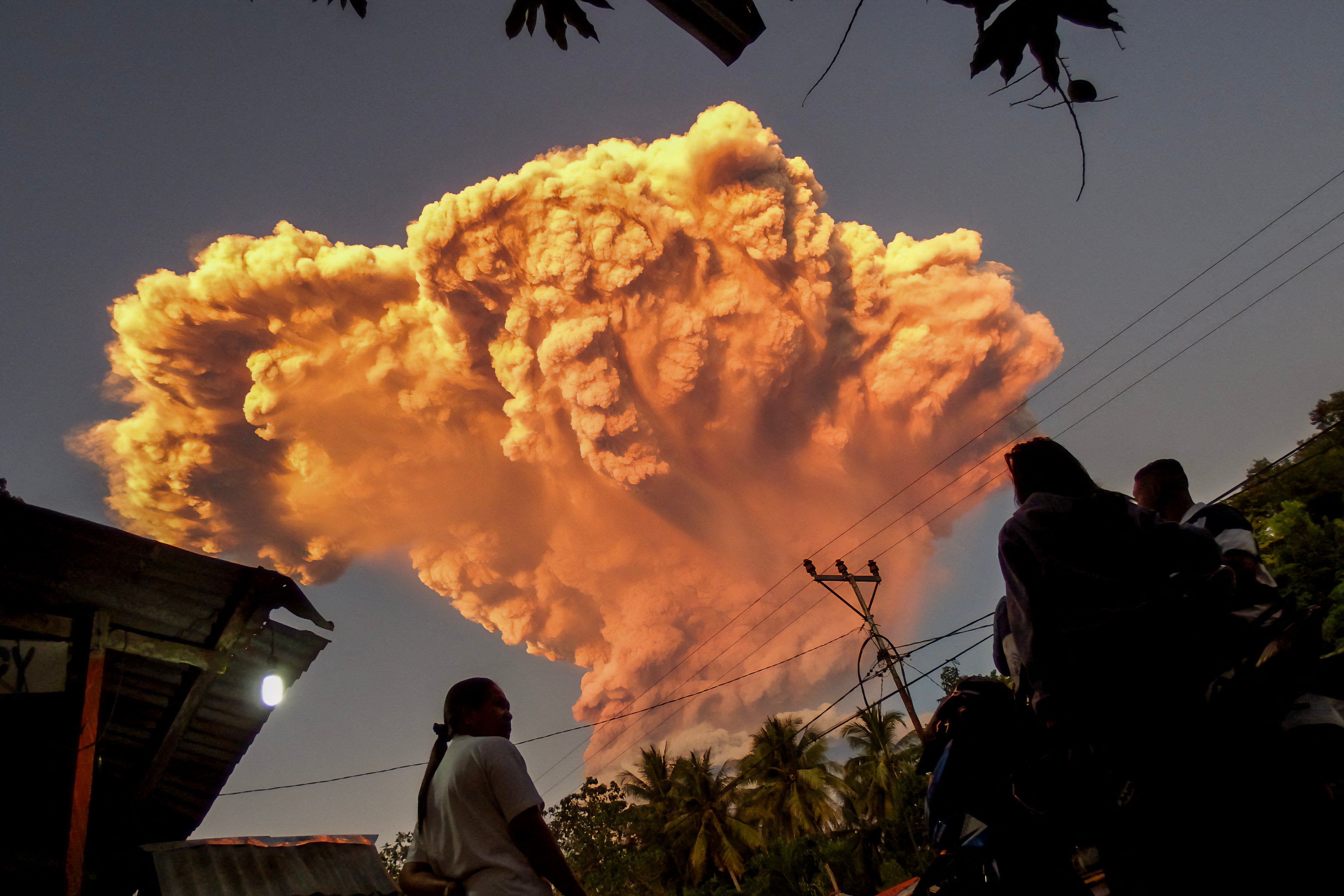 Villagers watch the eruption of Mount Lewotobi Laki-Laki as seen from Talibura village in Sikka, East Nusa Tenggar