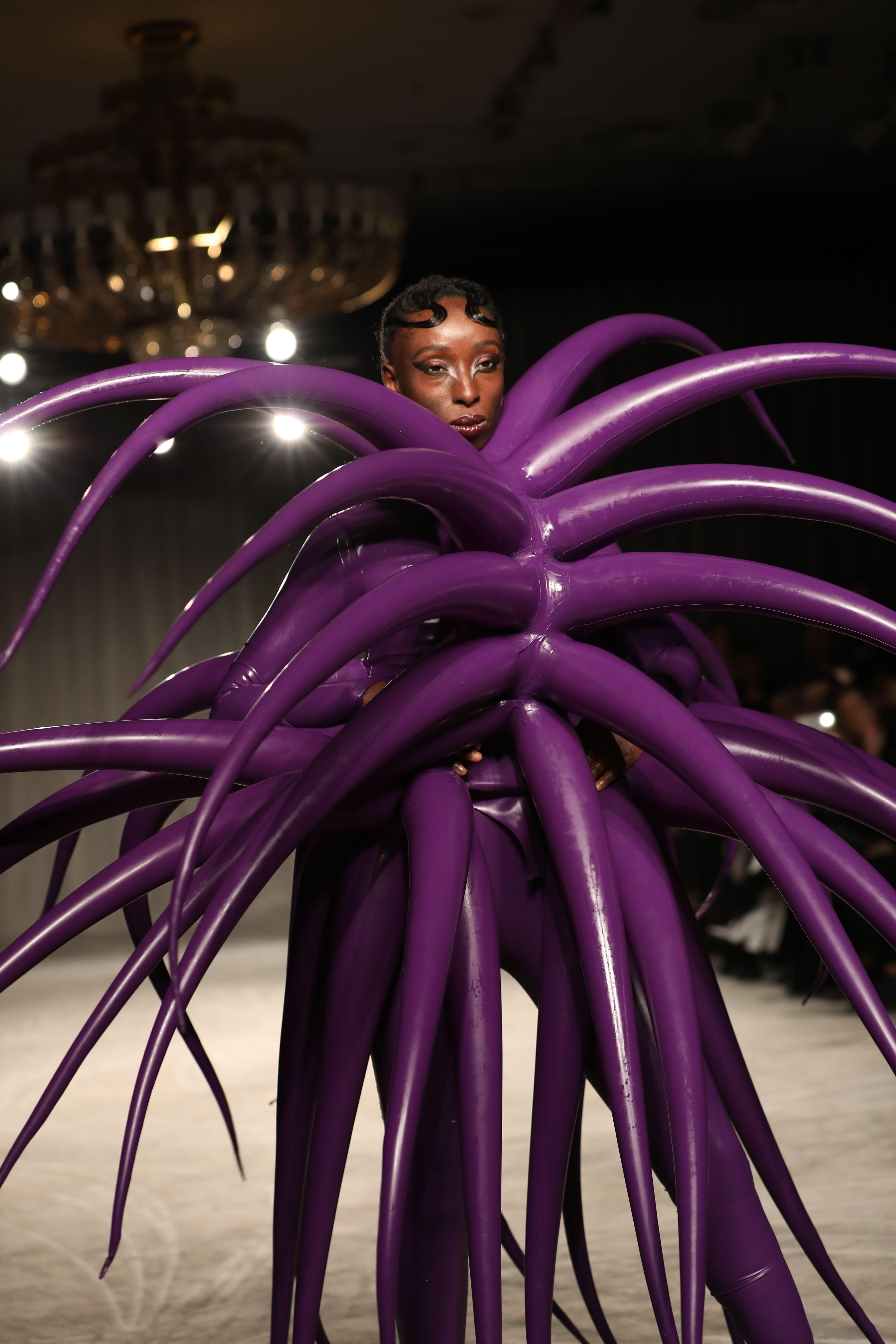 Olumide walking in London Fashion Week (Alamy/PA)