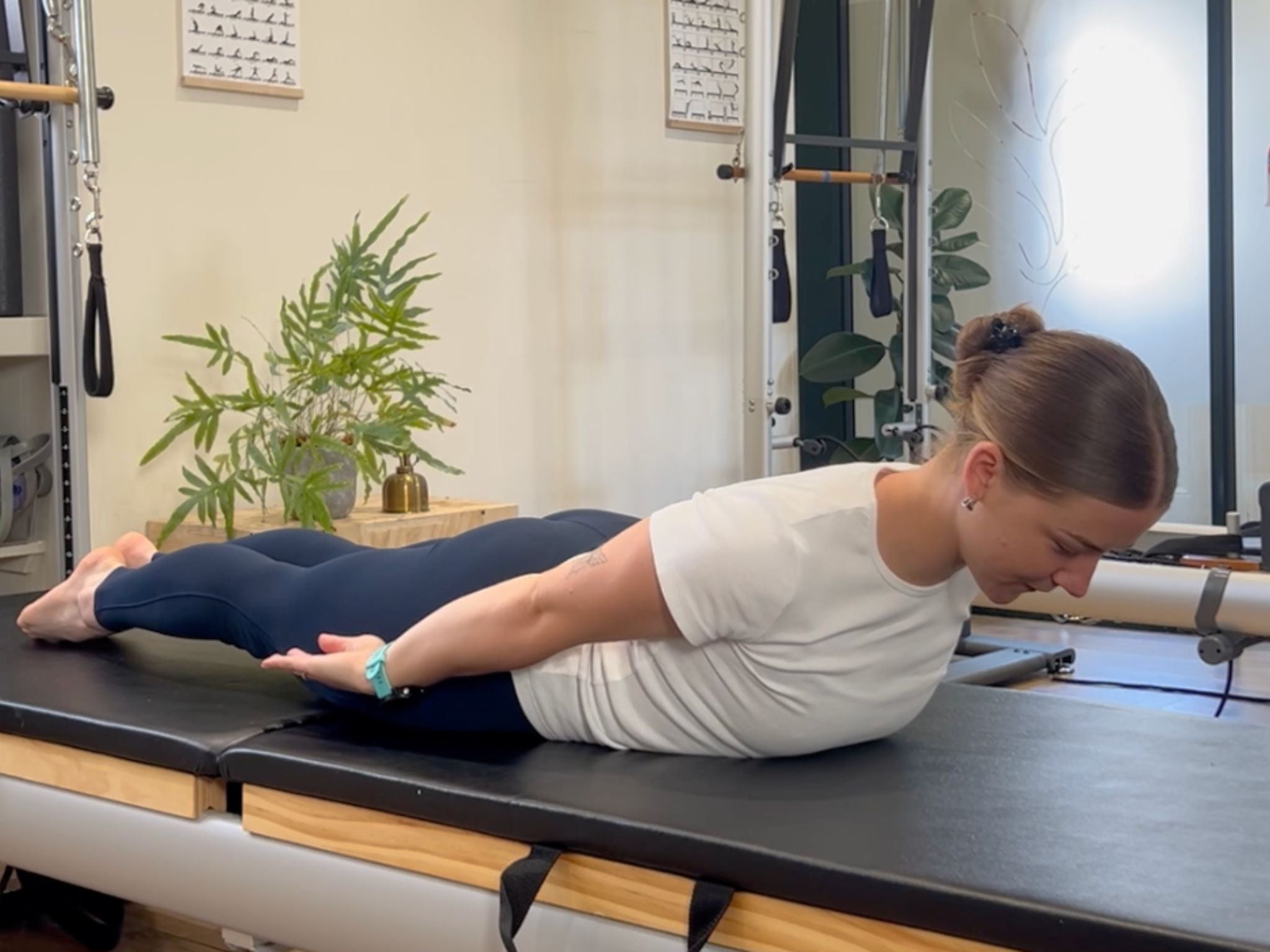 Pilates instructor Kasey Lach demonstrating the top position of the prone back extension