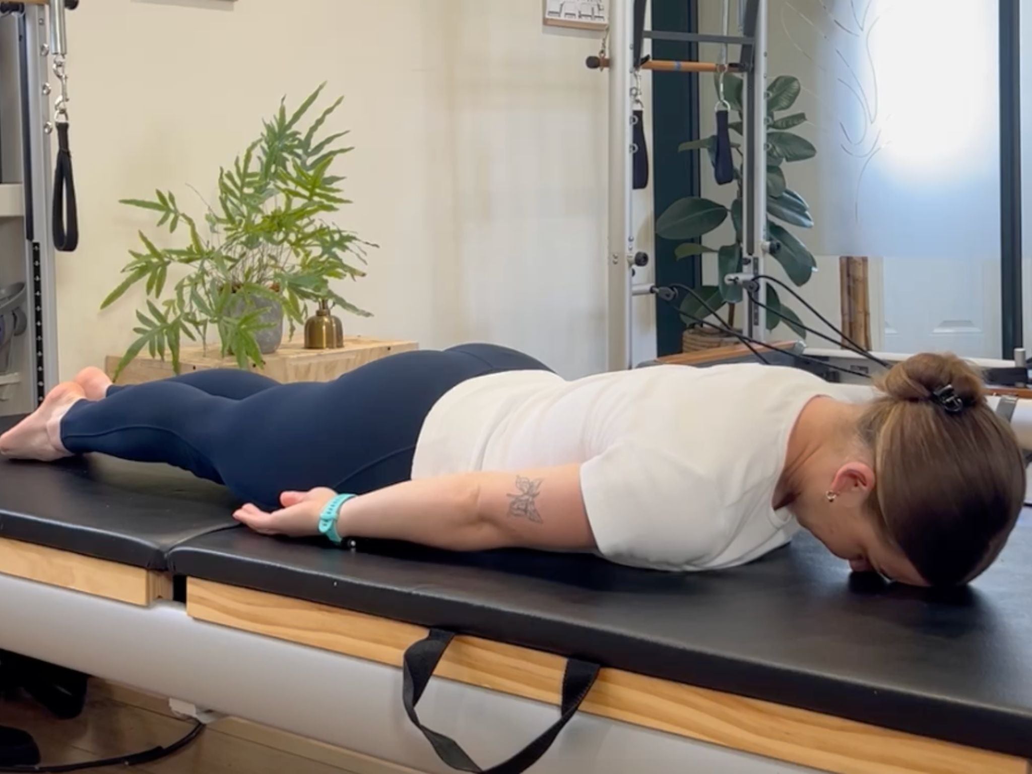 Pilates instructor Kasey Lach demonstrating the start position for the prone back extension