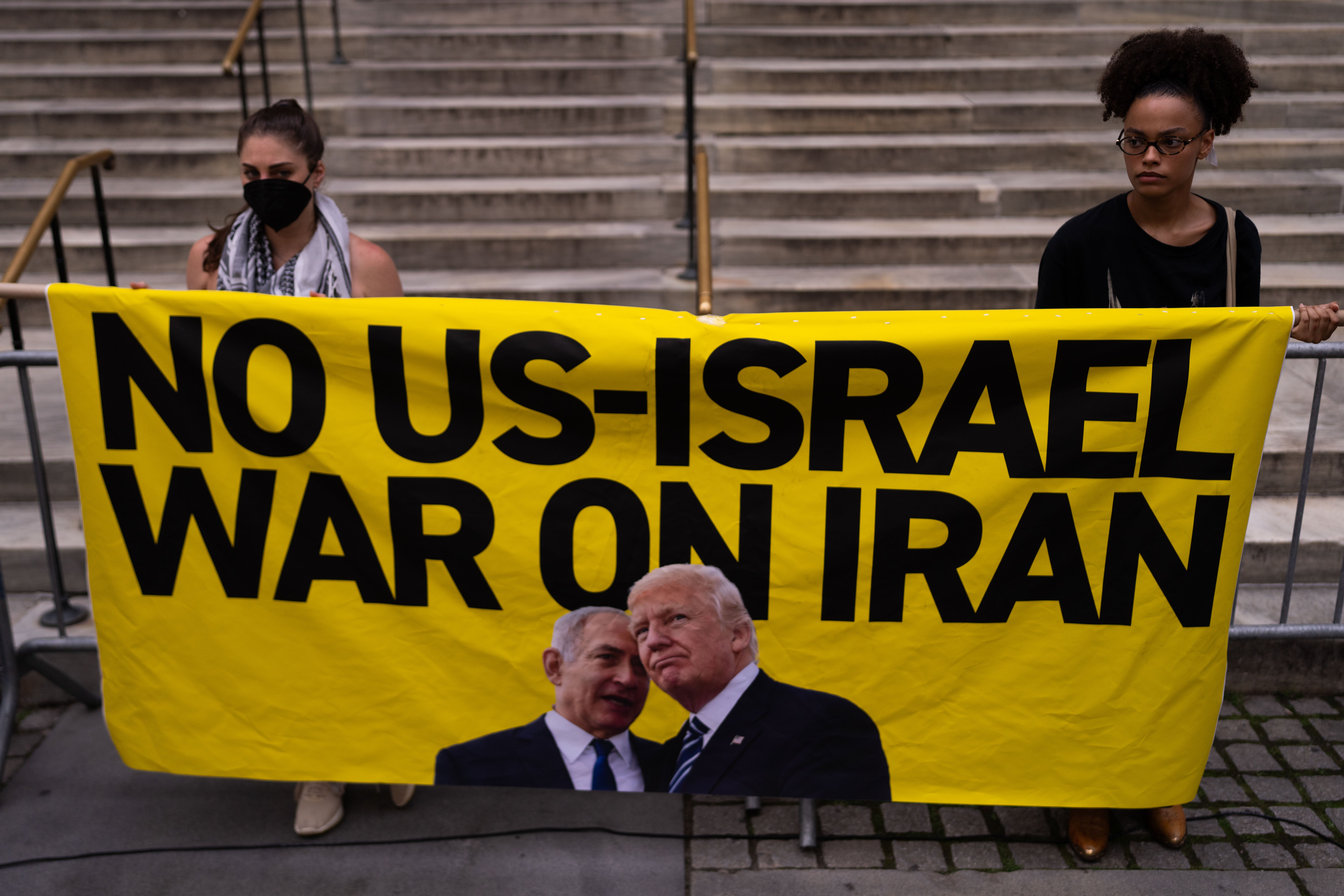 People attend a New York rally calling for the Trump administration not to go to war with Iran