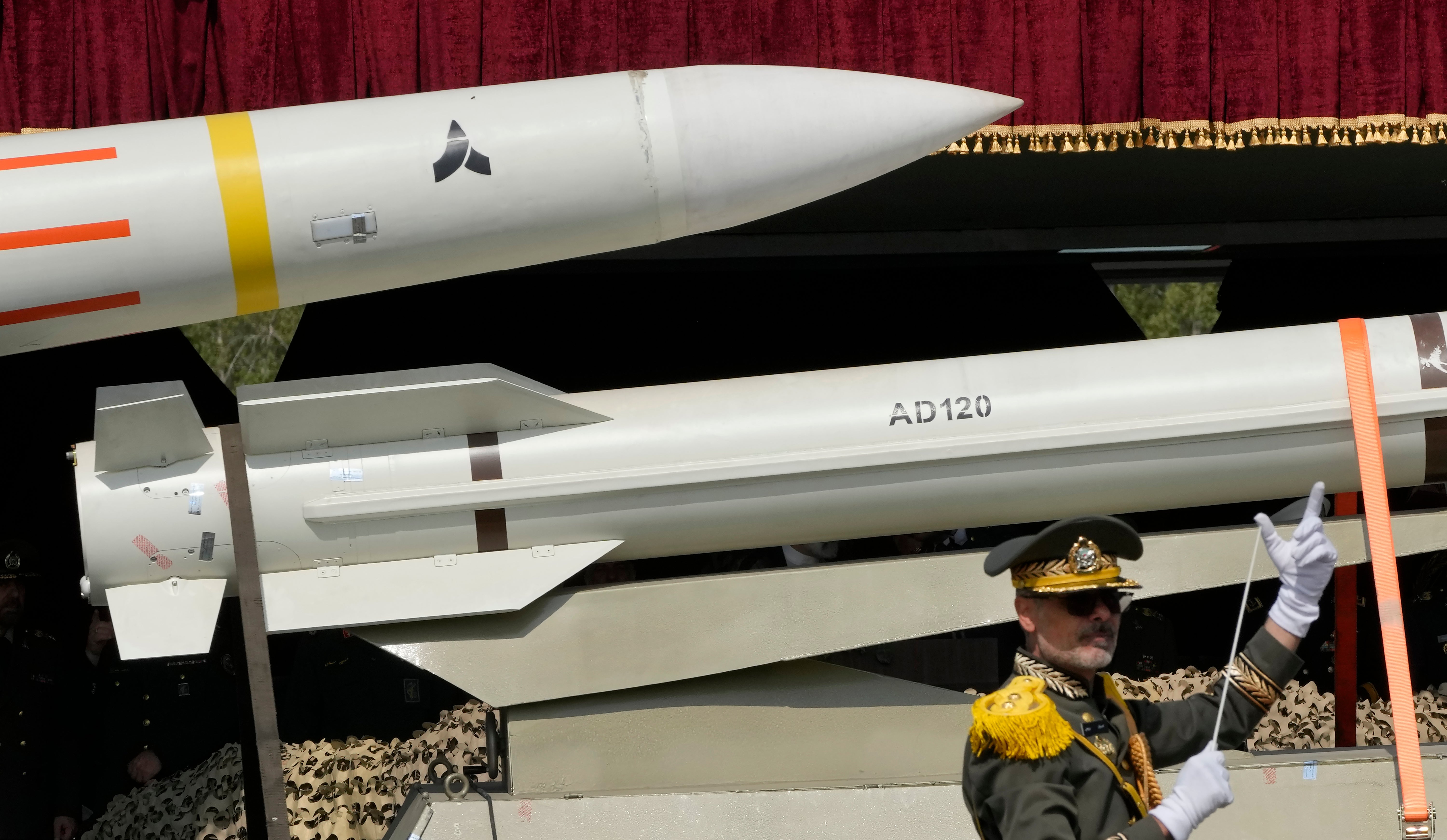 Missiles carried on an Iranian truck as an army band leader conducts a military band during an Army Day parade in Tehran last year