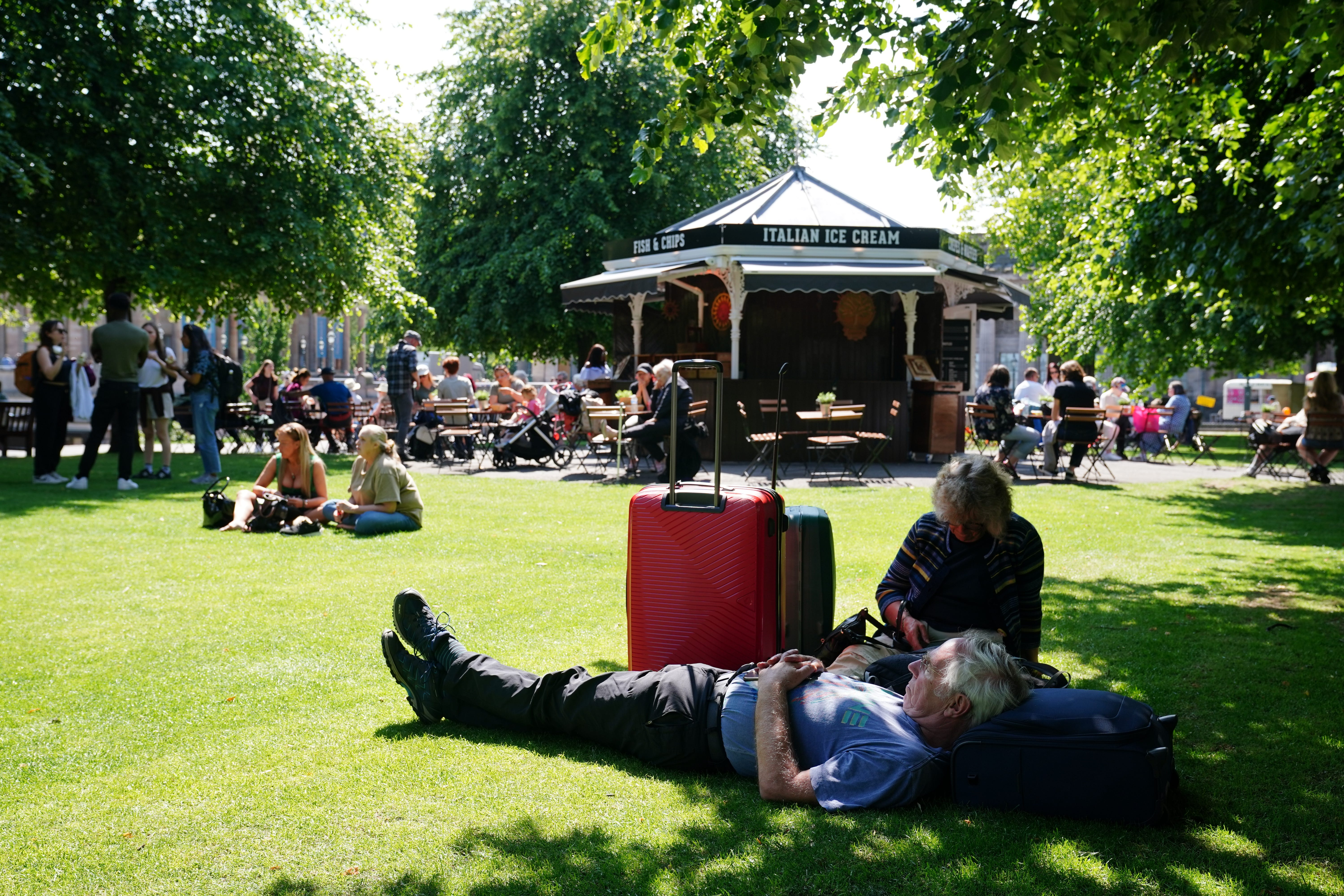 People enjoying the warm weather in Edinburgh’s Princes Street Gardens (Jane Barlow/PA)