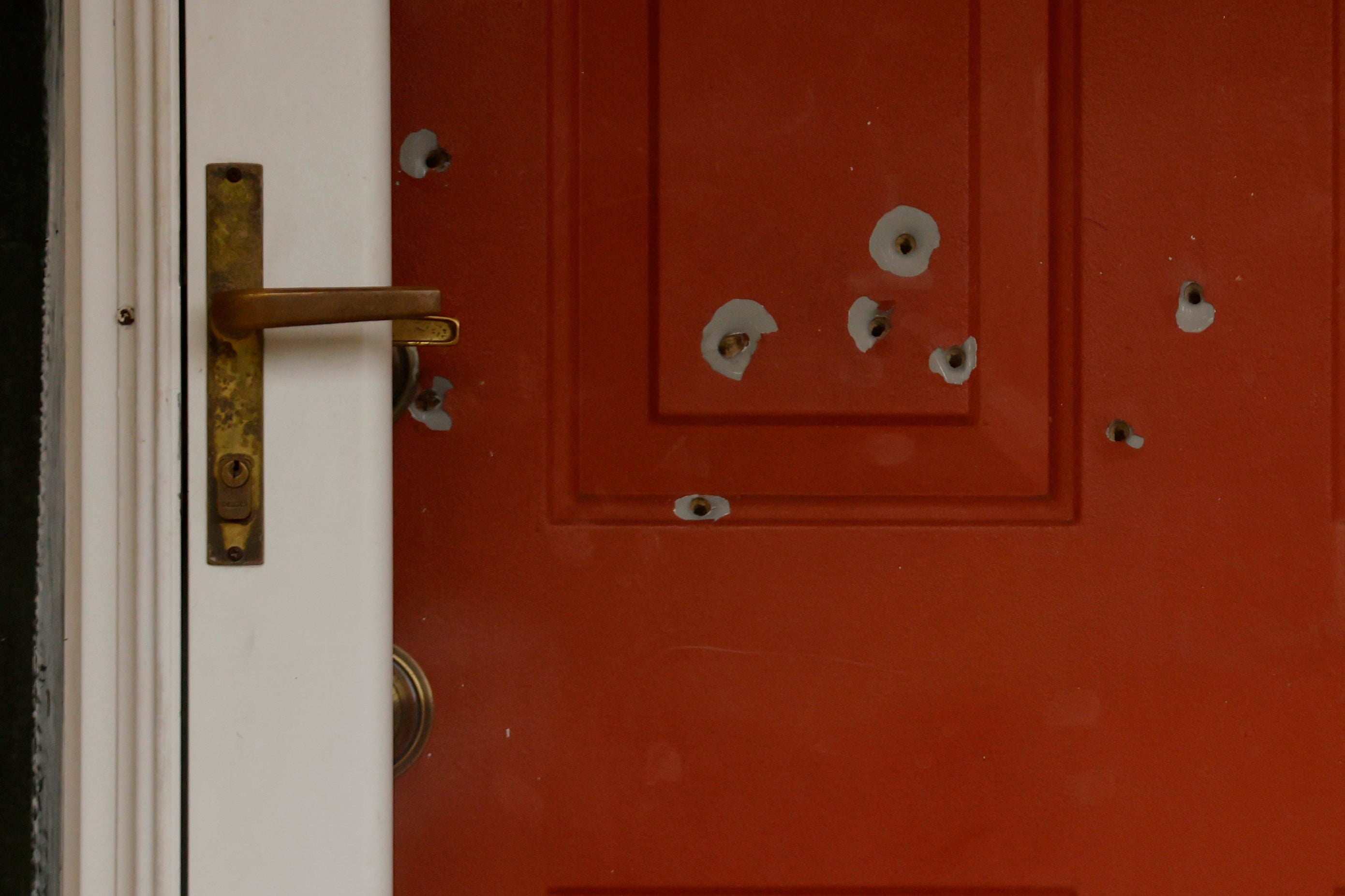 Bullet holes can be seen on the Hoffman’s front door.
