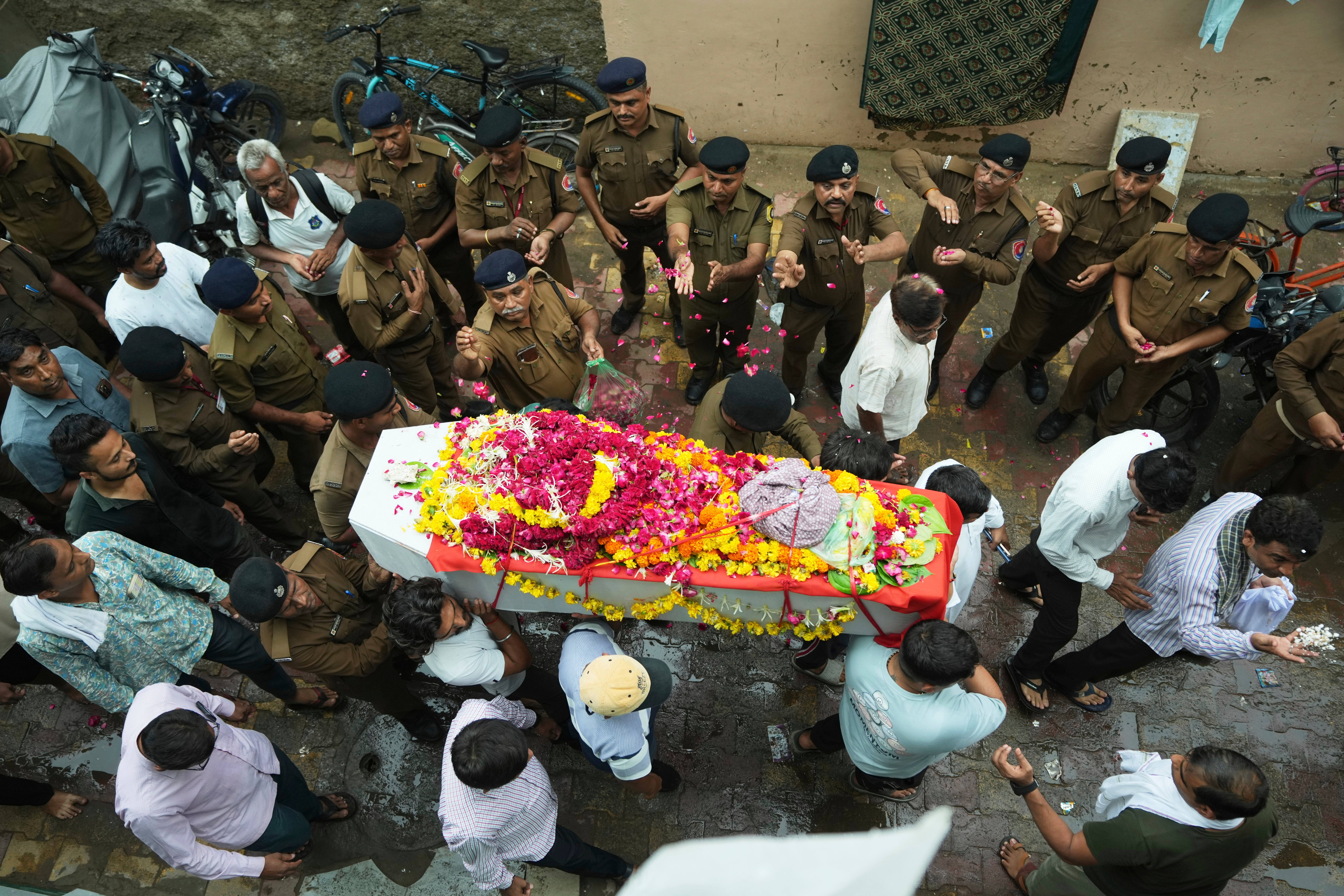 People carry the coffin of Rajendra Patankar, a victim of the Air India plane crash, in Ahmedabad on 19 June 2025