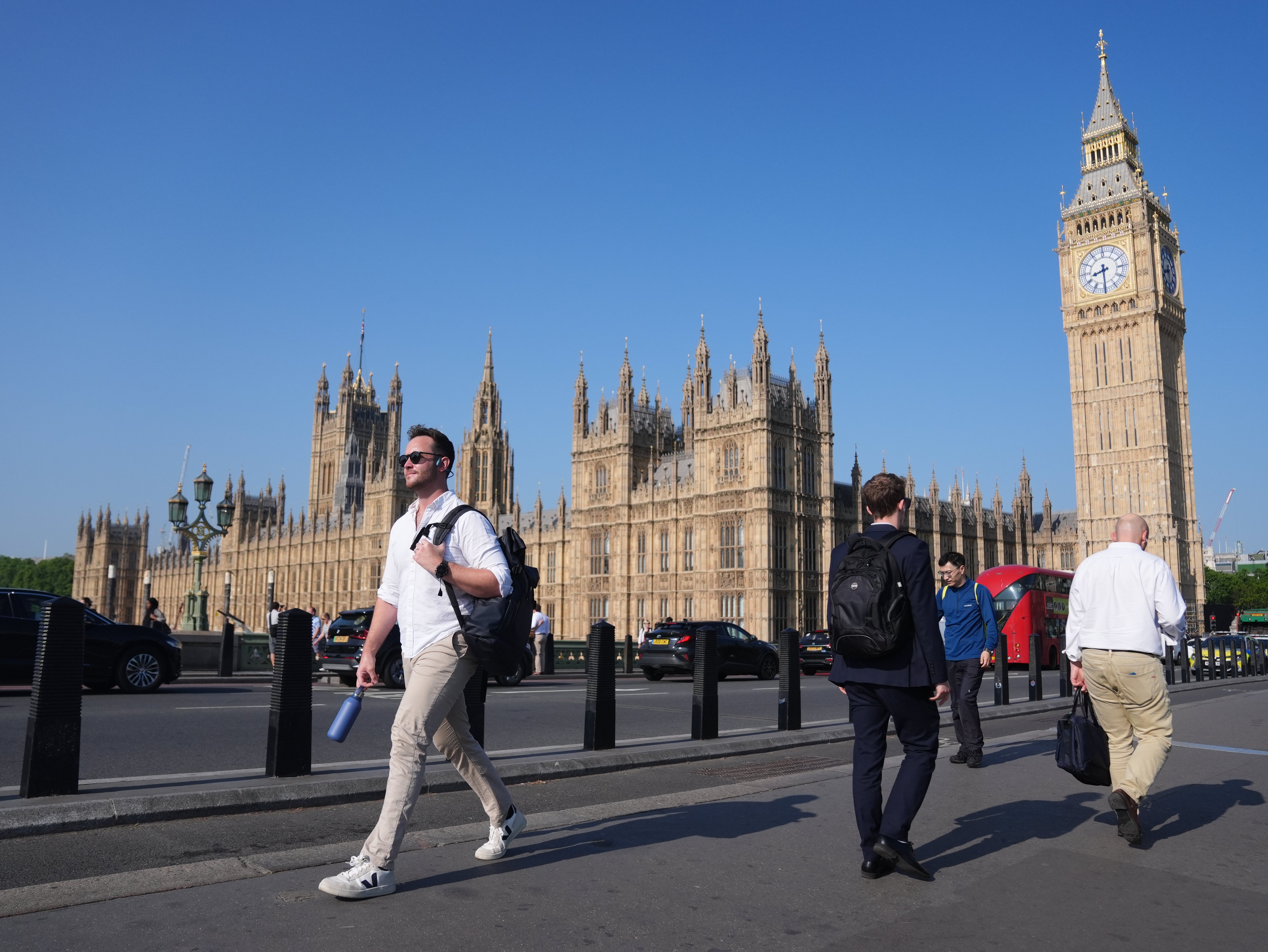 Commuters make their way past the Houses of Parliament on Thursday