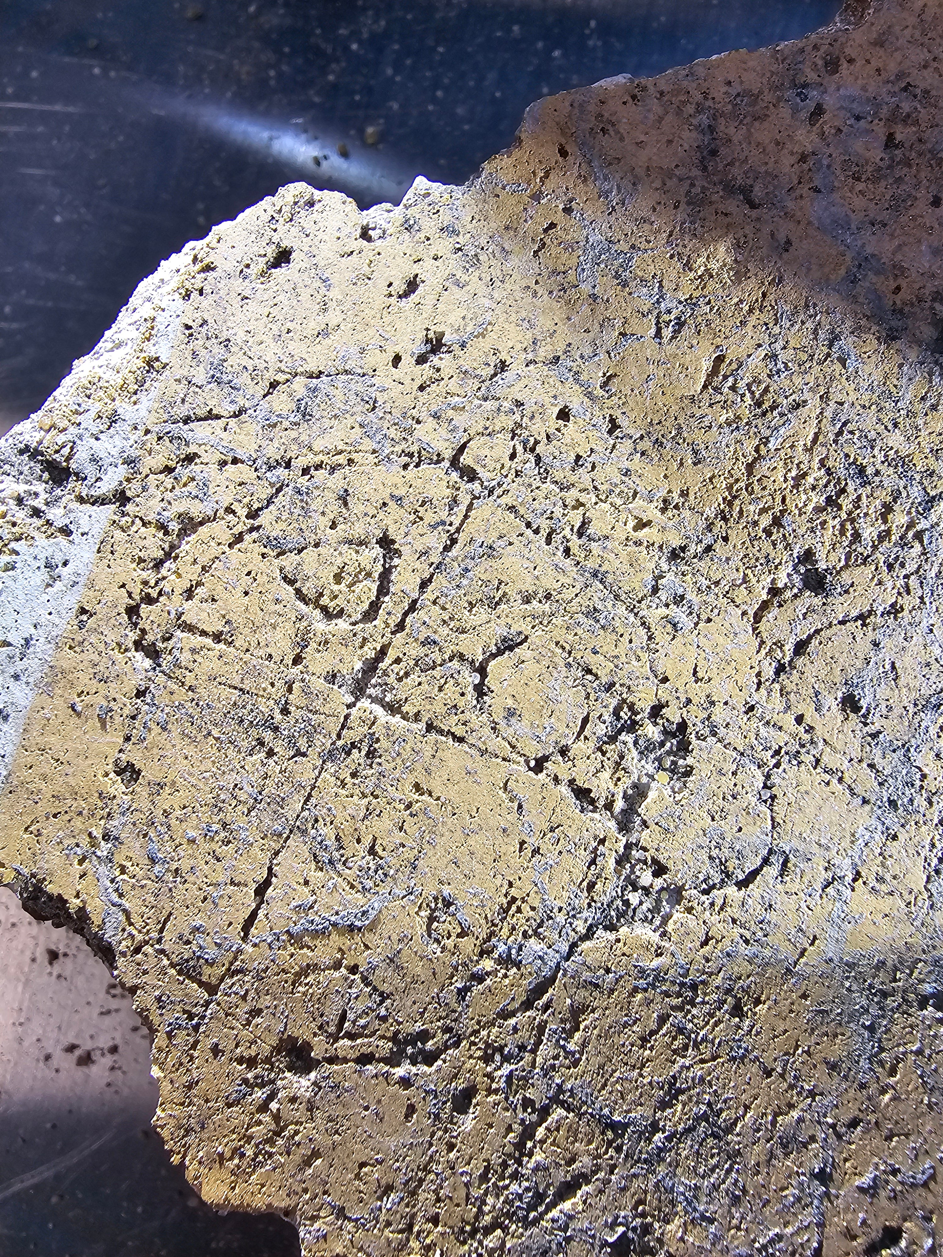 Roman graffiti of a crying face on the Liberty wall plaster