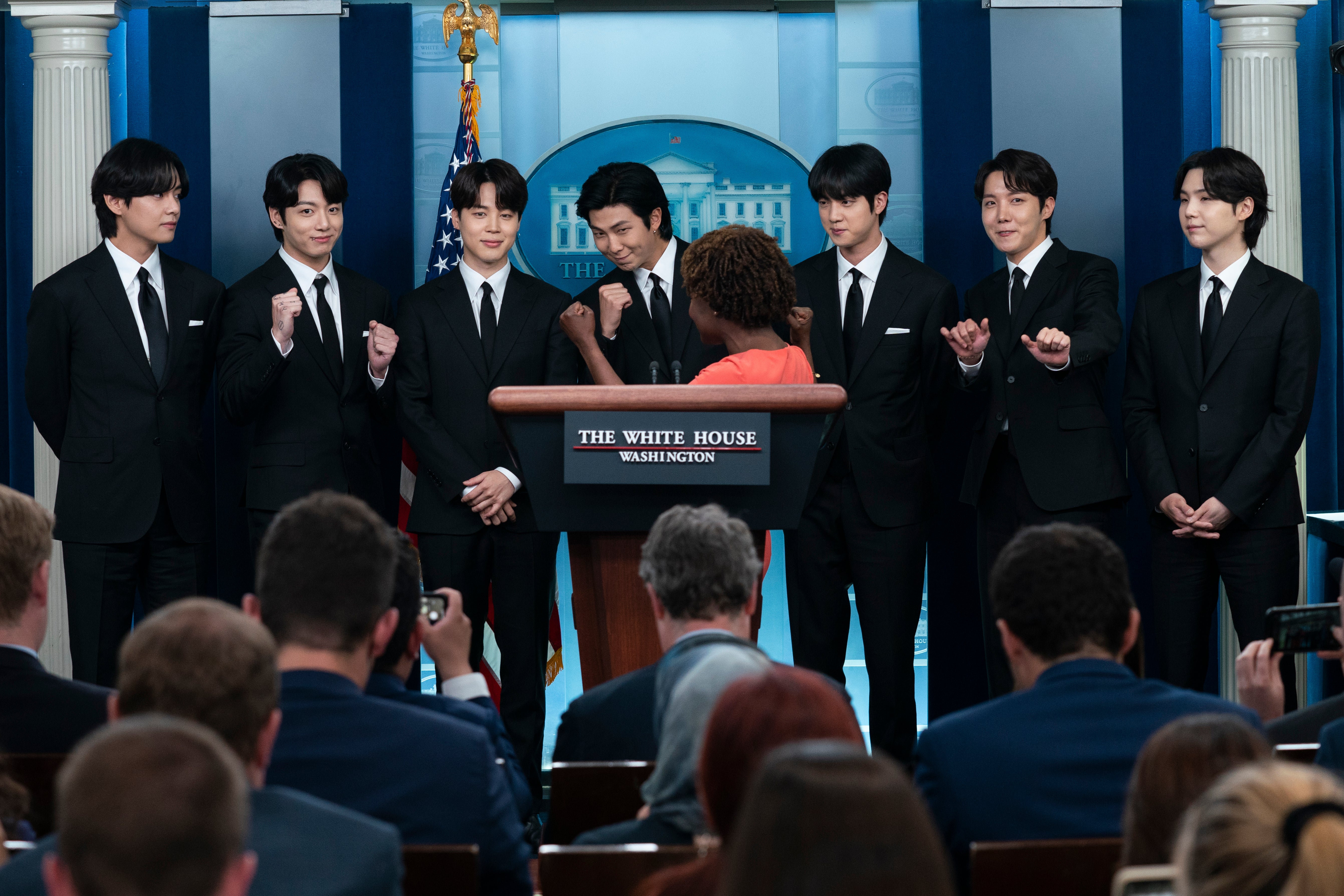 FILE - Members of the K-pop supergroup BTS from left, V, Jungkook, Jimin, RM, Jin, J-Hope, and Suga join White House press secretary Karine Jean-Pierre during the daily briefing at the White House, Tuesday, 31 May 2022, in Washington