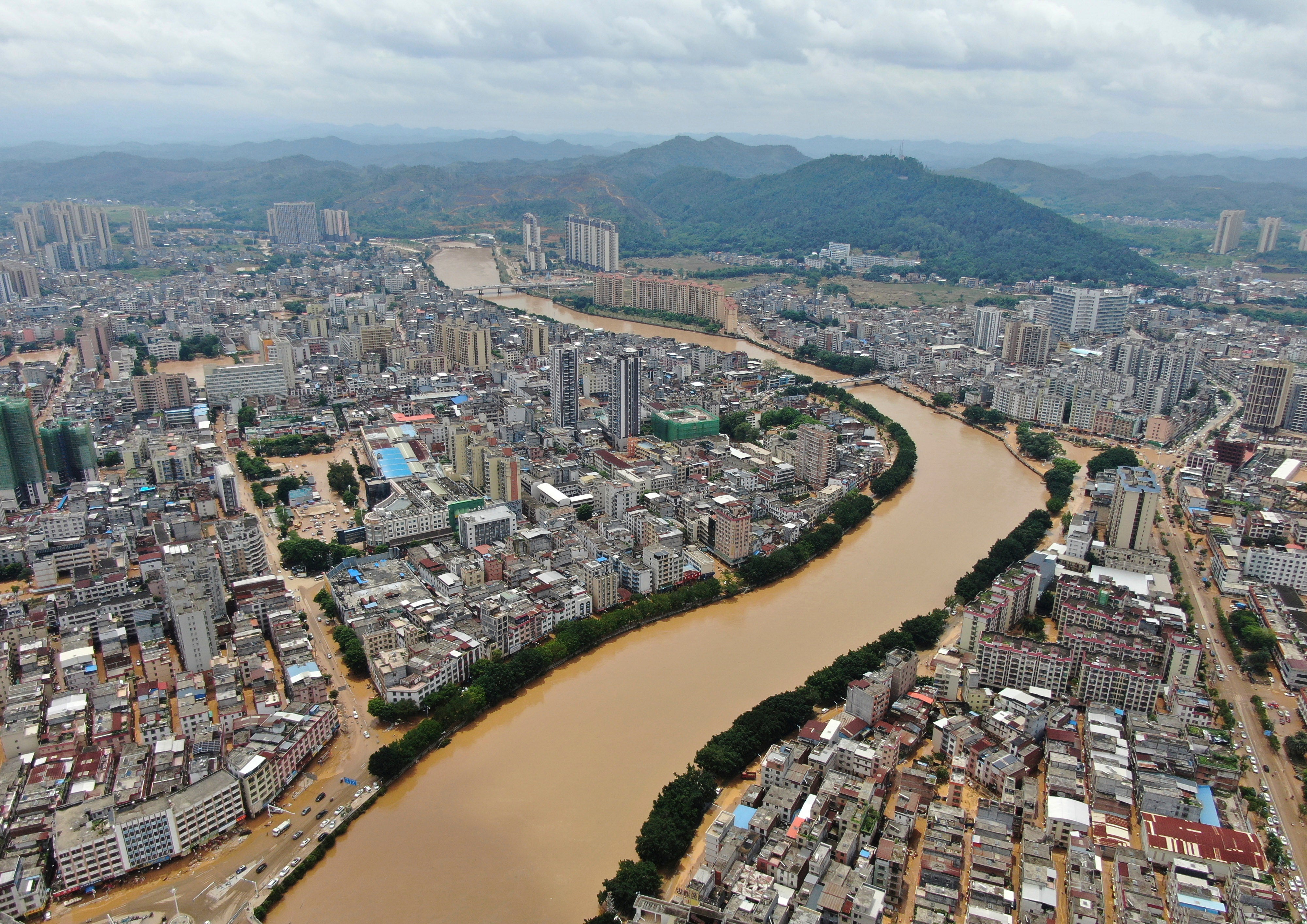Floodwaters from a river overwhelm towns after days of heavy rainfall in Huaiji county of south China's Guangdong province in June