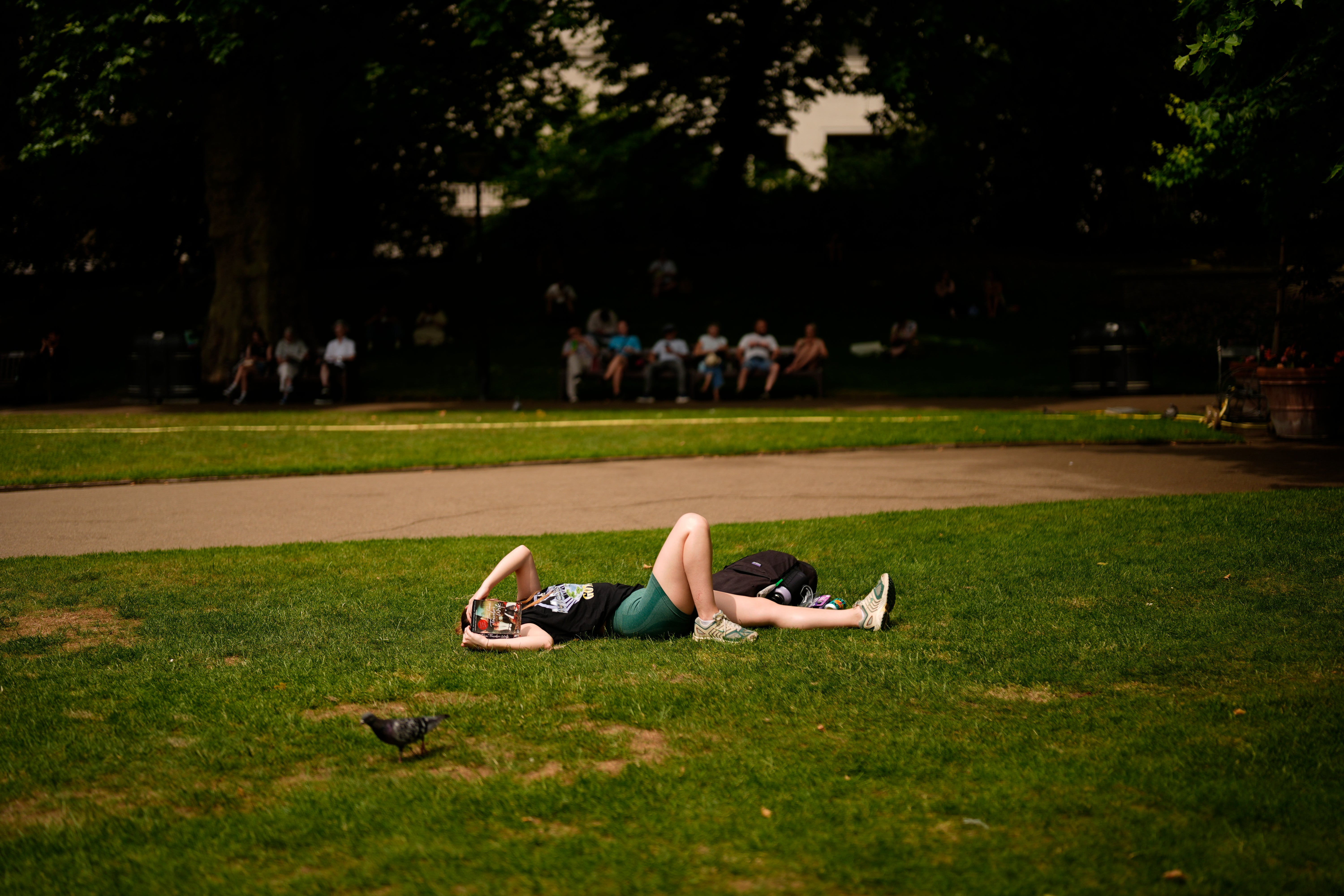 People enjoy the hot weather in Victoria Embankment Gardens, London