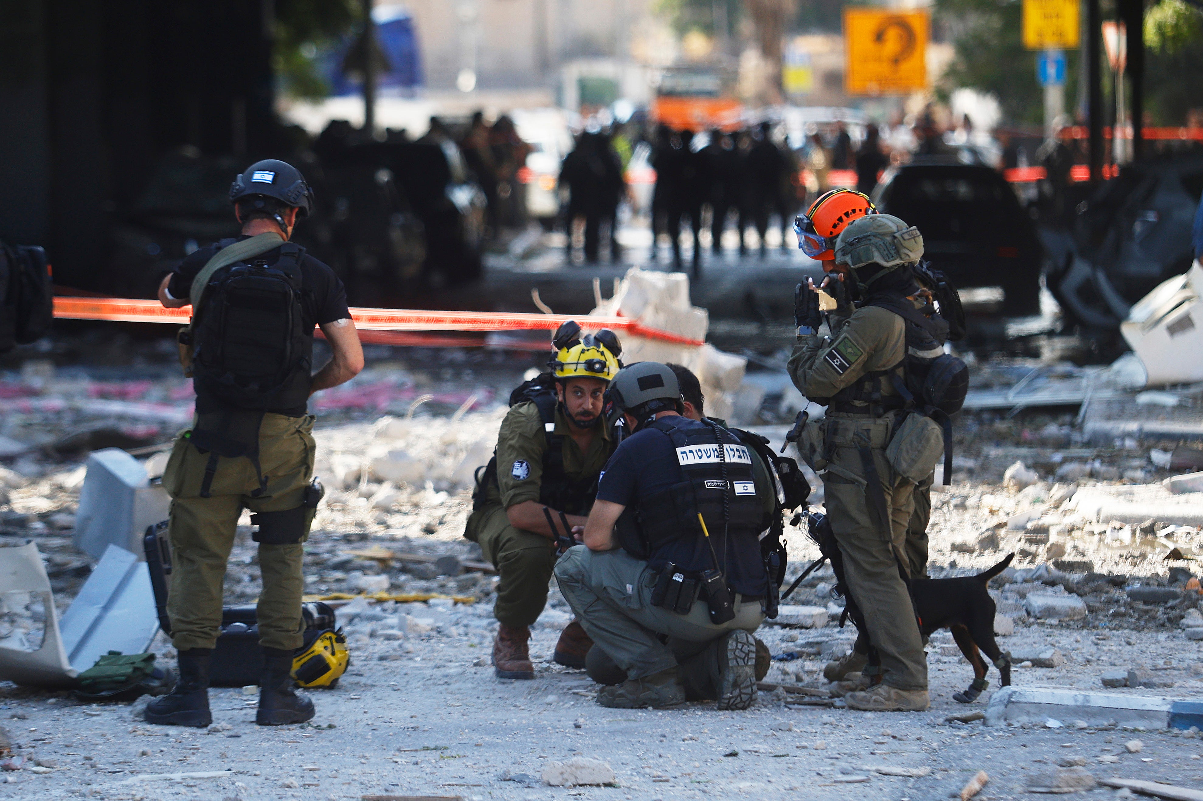 Israeli security forces cordon-off an area officials say was hit by an Iranian strike in Haifa