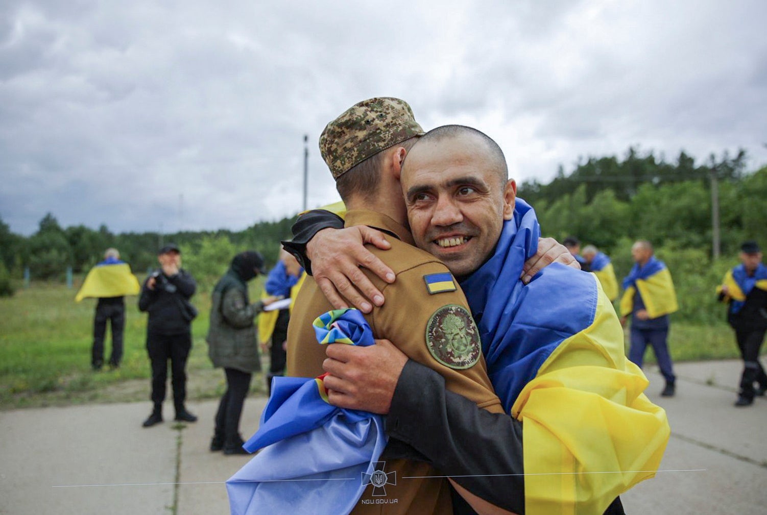 A handout photo made available by the National Guard of Ukraine shows Ukrainian prisoners of war (POWs) reacting following a prisoner swap at an undisclosed location in Ukraine, 20 June 2025