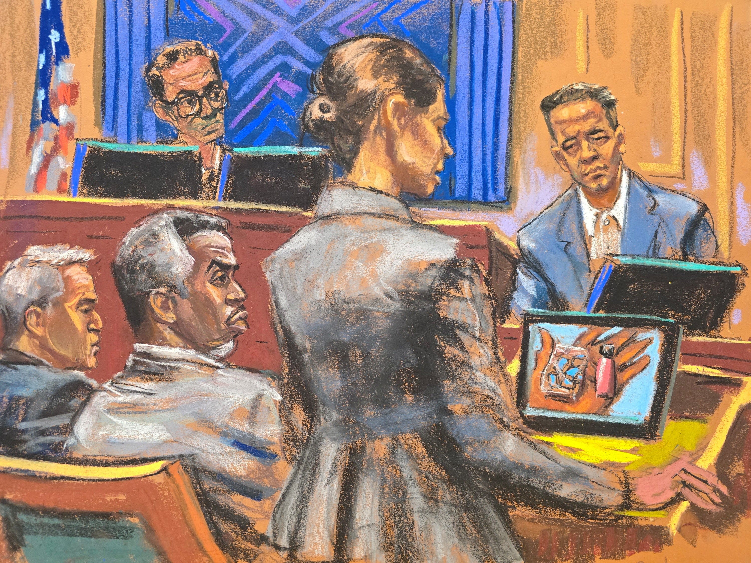 Sean "Diddy" Combs listens as Assistant U.S. Attorney Christy Slavik questions Brendan Paul during Combs' sex trafficking trial.
