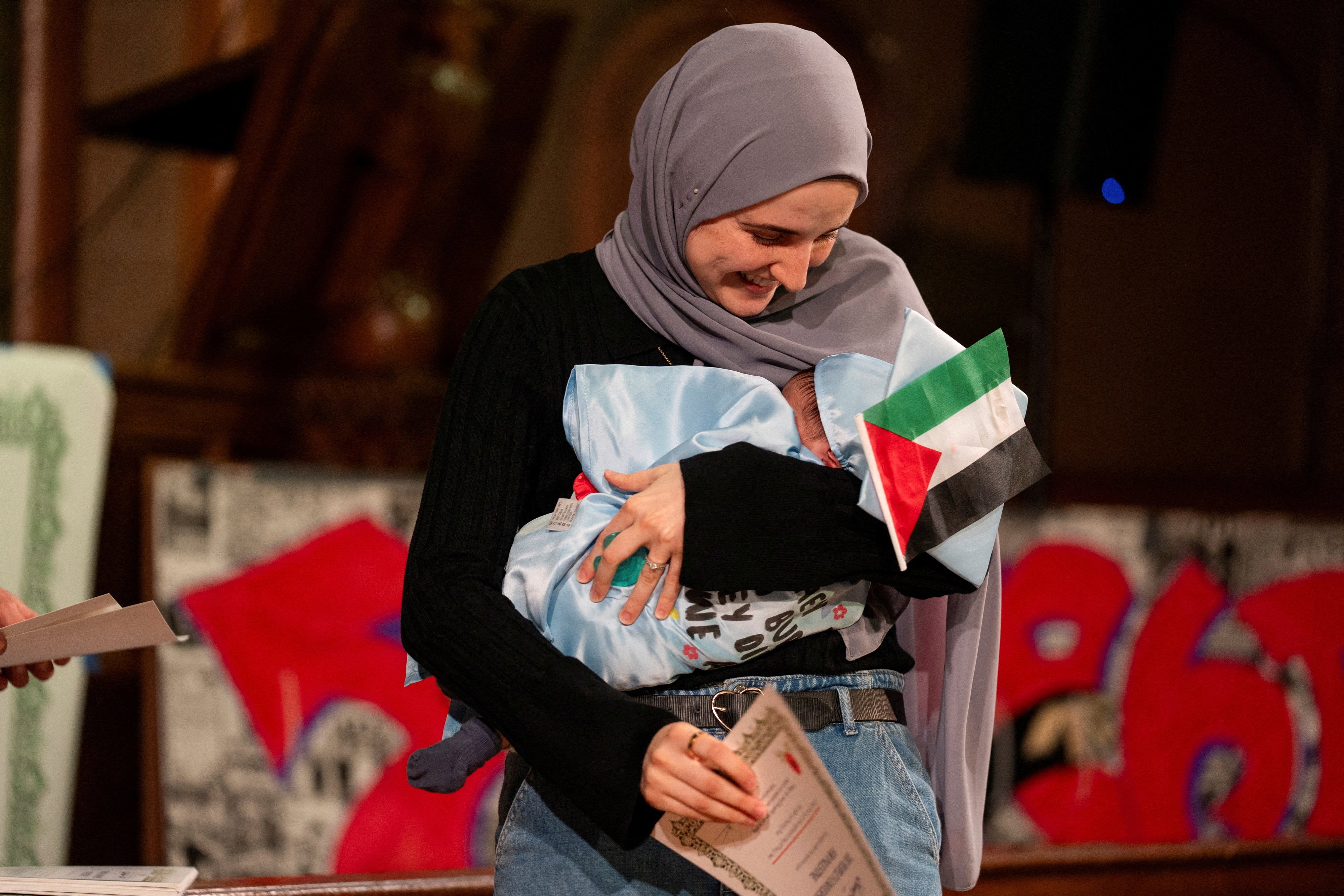 Khalil’s wife Noor Abdalla, holding their son who was born while he was in ICE detention, said the family ‘can finally breathe a sigh of relief’ after a ruling on his release