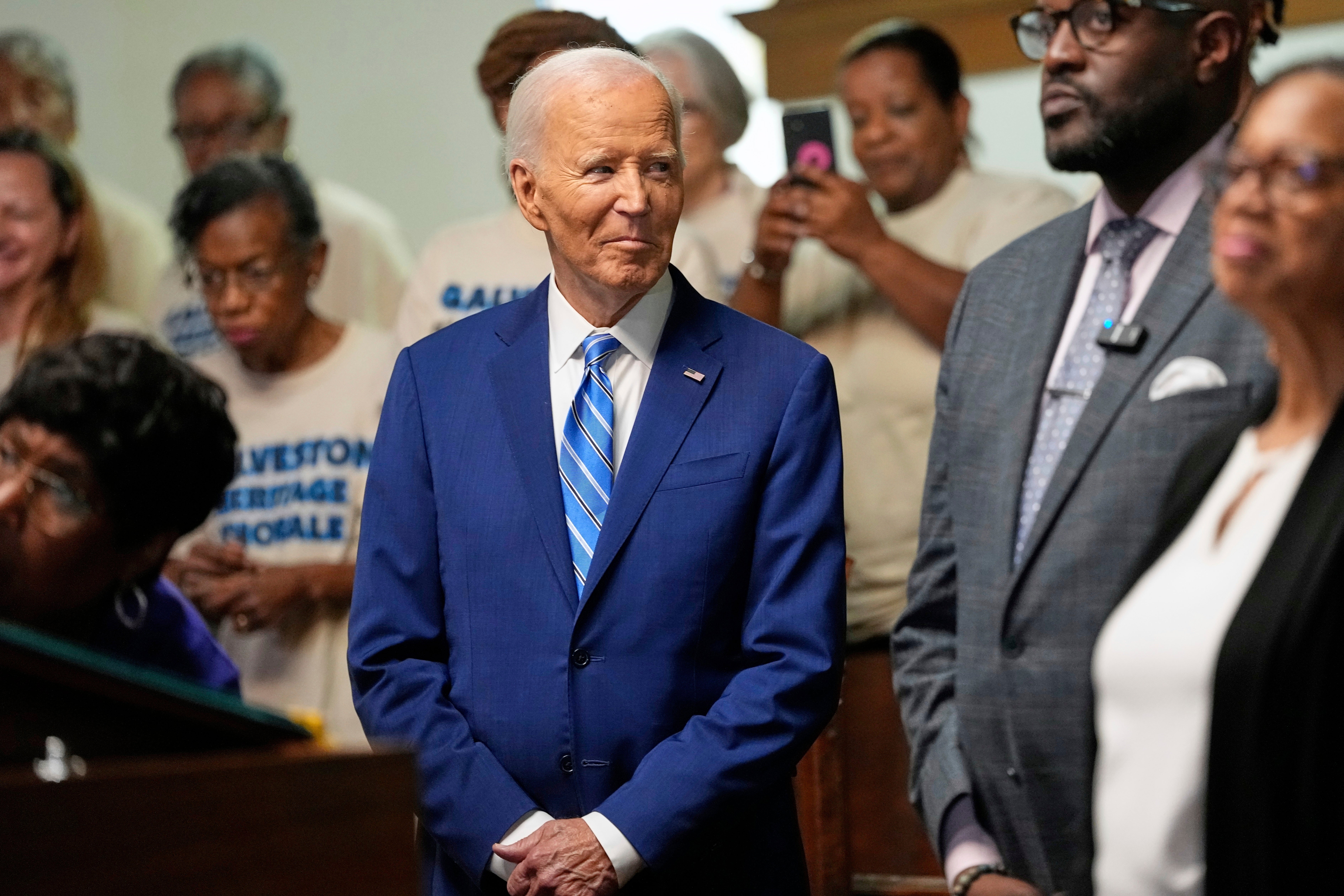 Former President Joe Biden stands as he prepares to speak at a Juneteenth celebration in Galveston, Texas