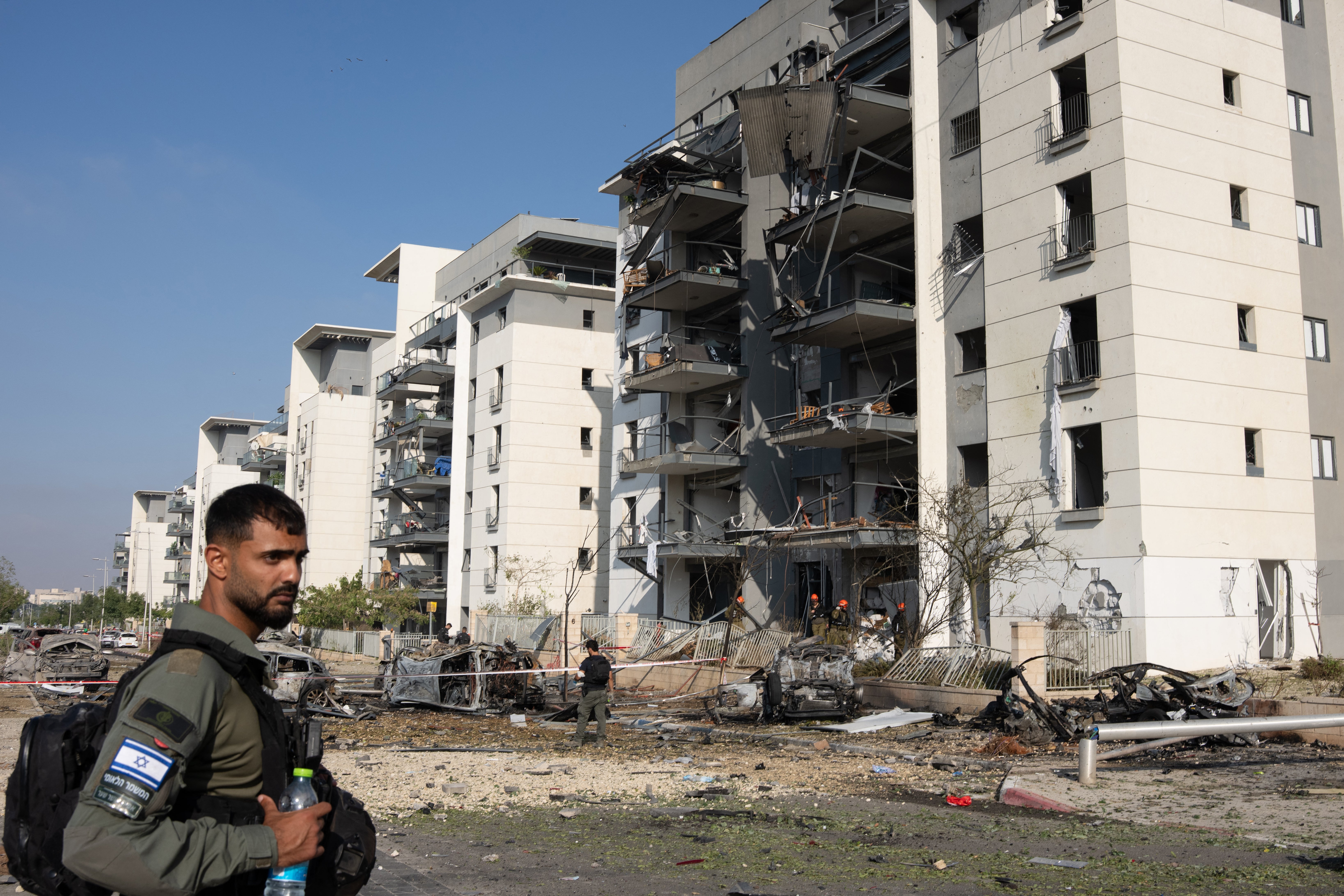 A member of the Israeli security forces checks the destruction at site of an Iranian missile attack in a residential area in Beersheba in southern Israel