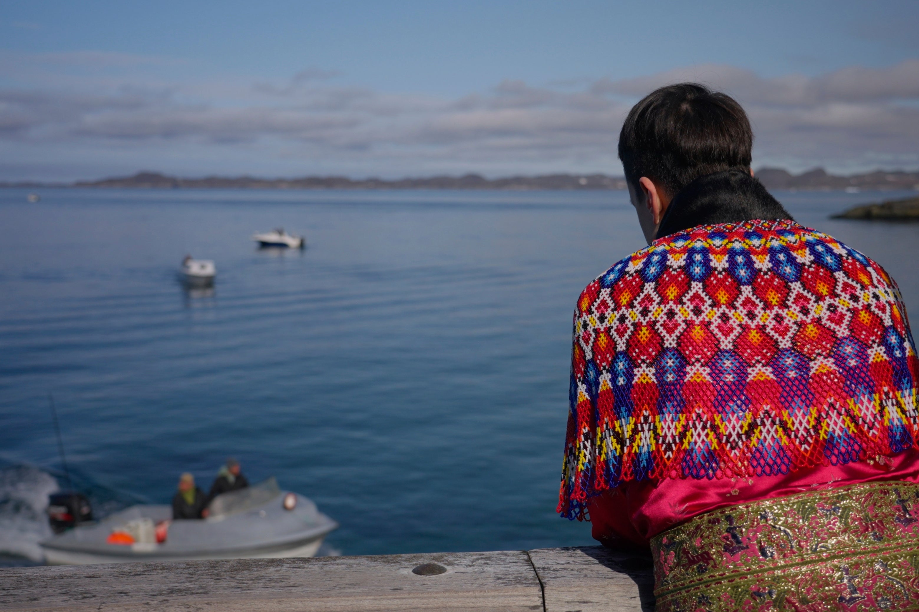 Local wearing a traditional clothing made of pearl collar and seal hides watch the seal hunting competition in Nuuk, Greenland (AP Photo/Kwiyeon Ha)